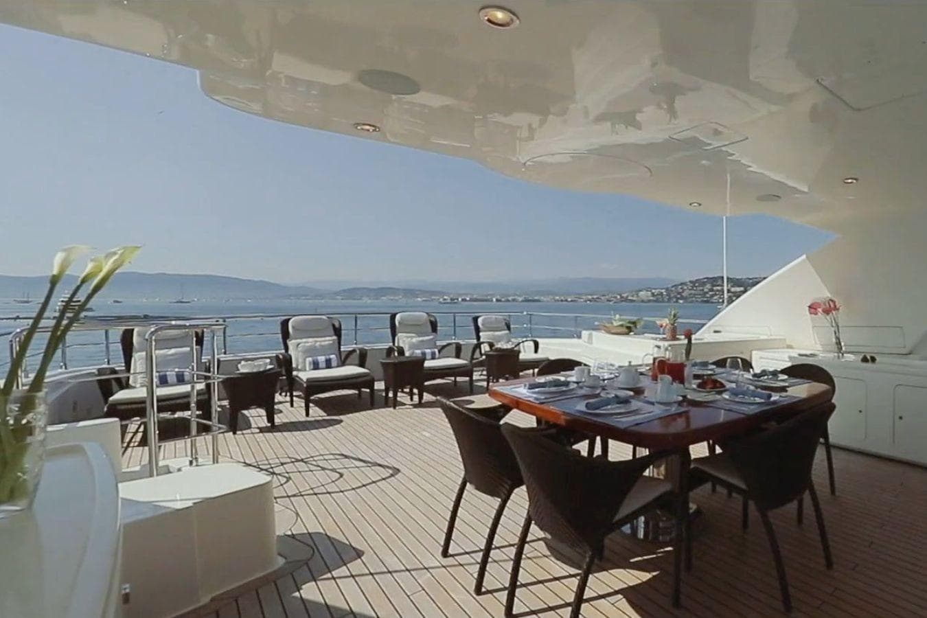 Luxurious CRN 128 yacht deck with dining area, ocean view, and elegant seating, 2007 model.