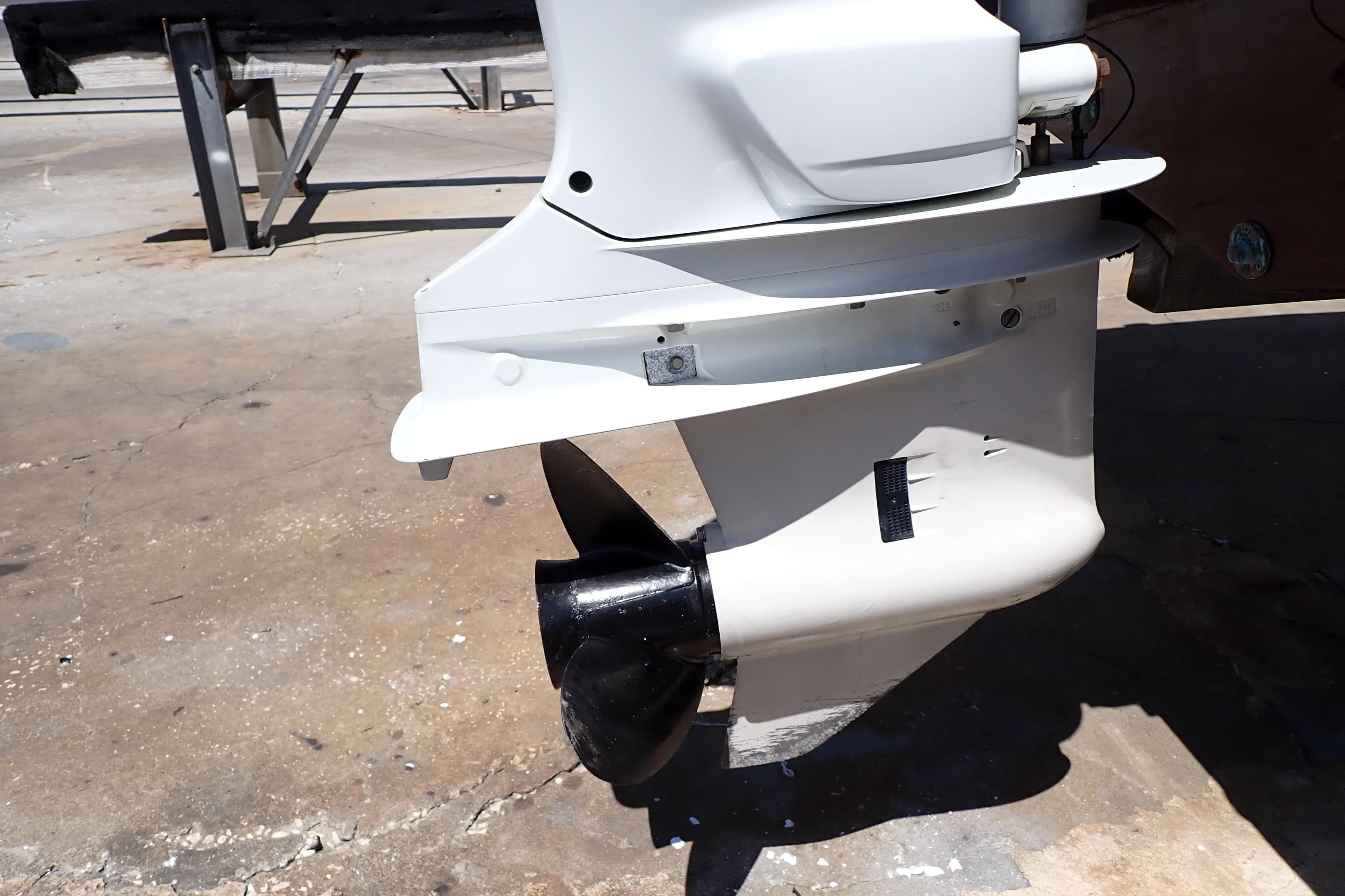 2021 Hurricane SunDeck Sport 185 OB outboard motor close-up on concrete surface.