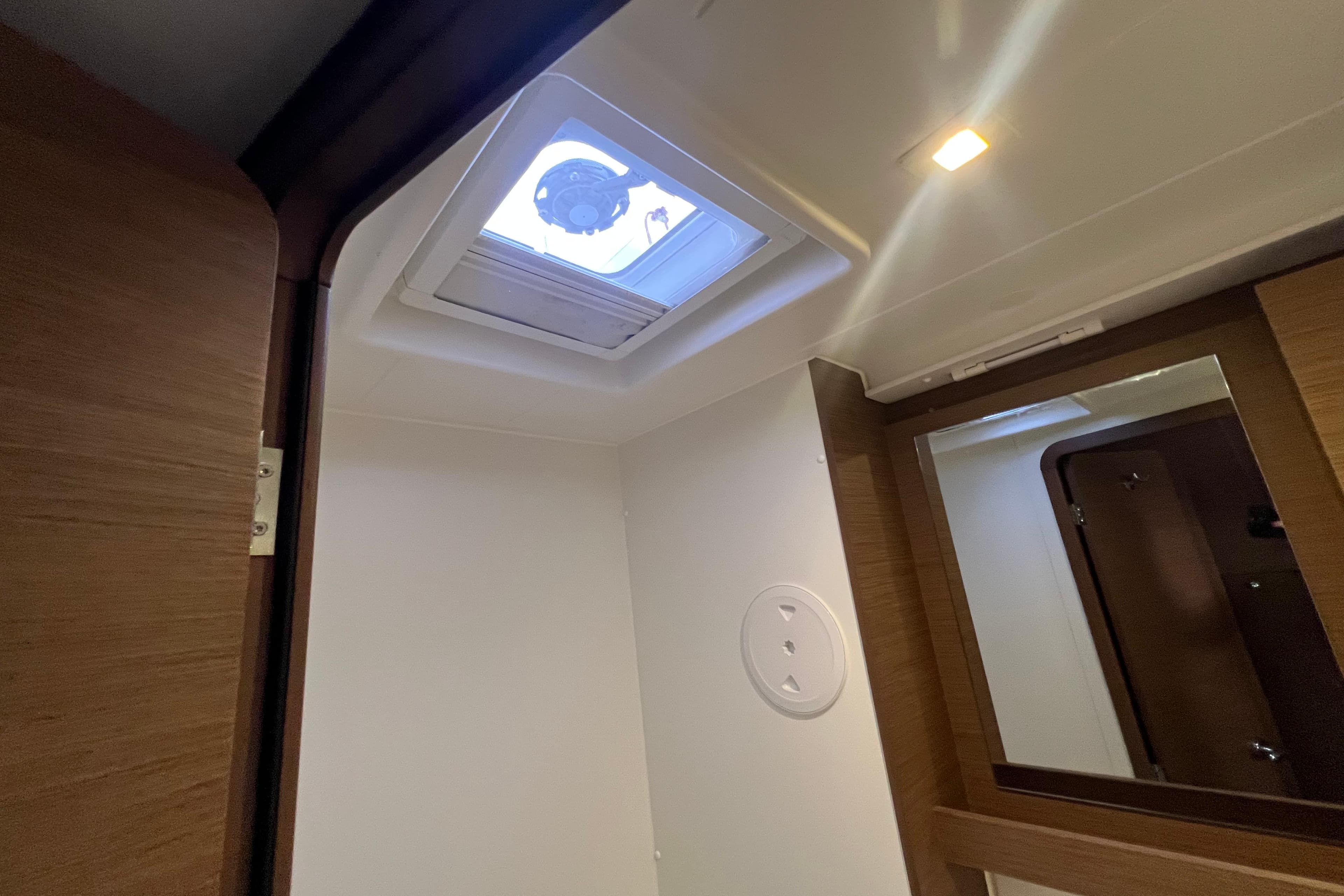 Interior of 2018 Lagoon 42 yacht, featuring a skylight and wooden accents.