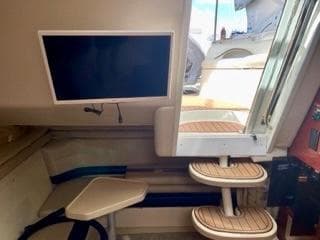 Interior of 2001 Wellcraft Martinique 3700 yacht with stairs and mounted TV.