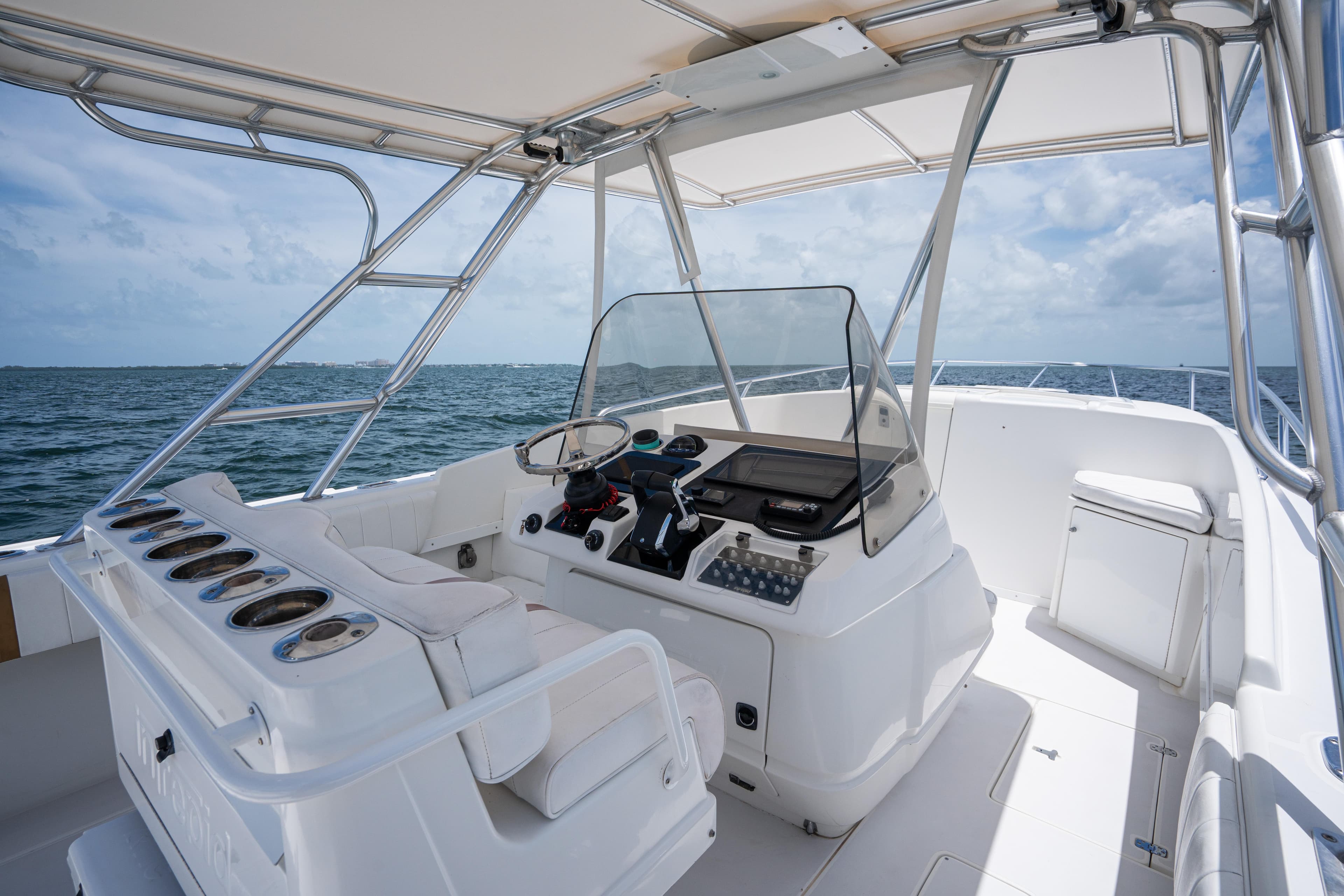 1999 Intrepid 35 boat interior with helm, ocean view, and clear sky.