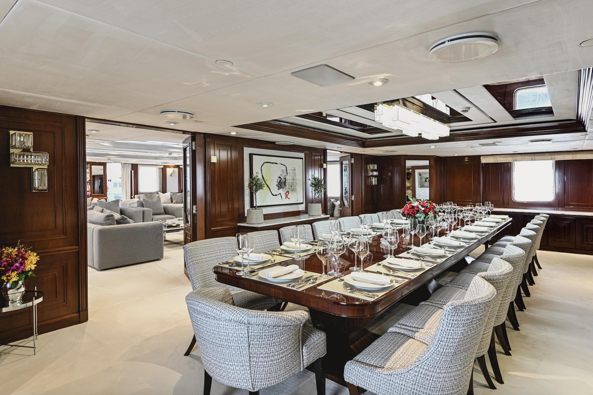 Luxurious dining room on Devonport 86m yacht, featuring elegant table setting and plush seating.