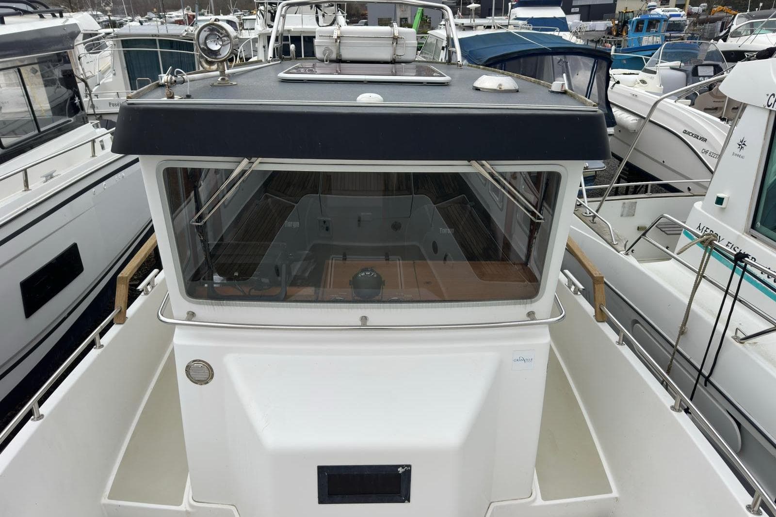 2012 Targa 27.1 GT boat docked among other vessels at a marina.