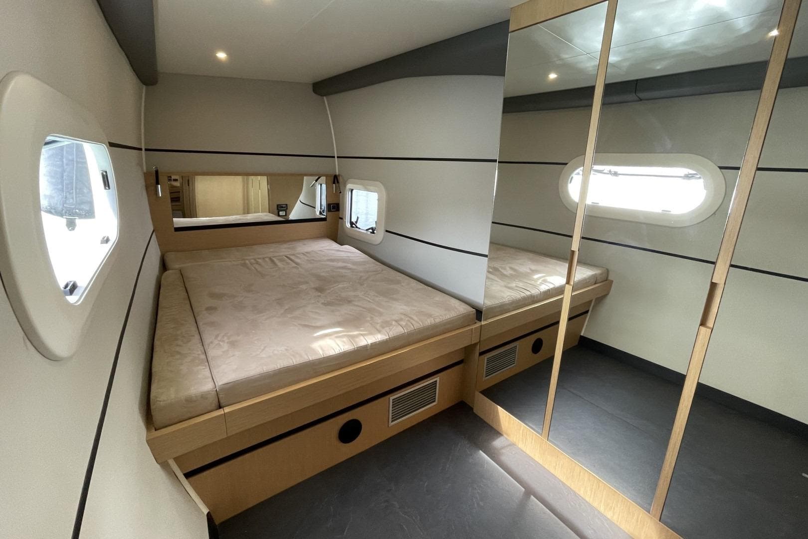 Luxurious bedroom interior of 2017 Ice Yachts Ice Cat 61 with modern design and ample lighting.
