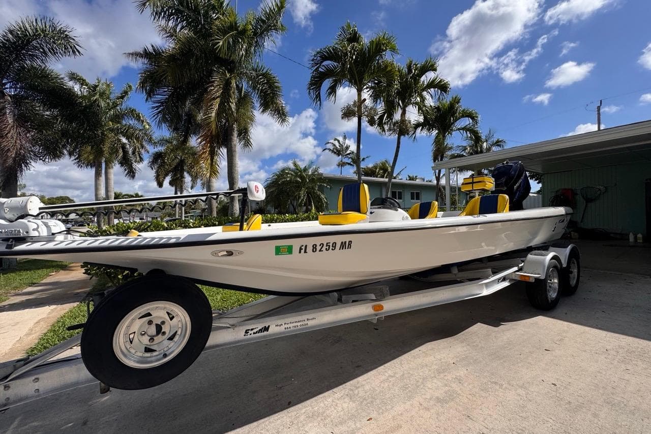 2005 Storm Boats Storm-High Performance on trailer, parked near palm trees under blue sky.
