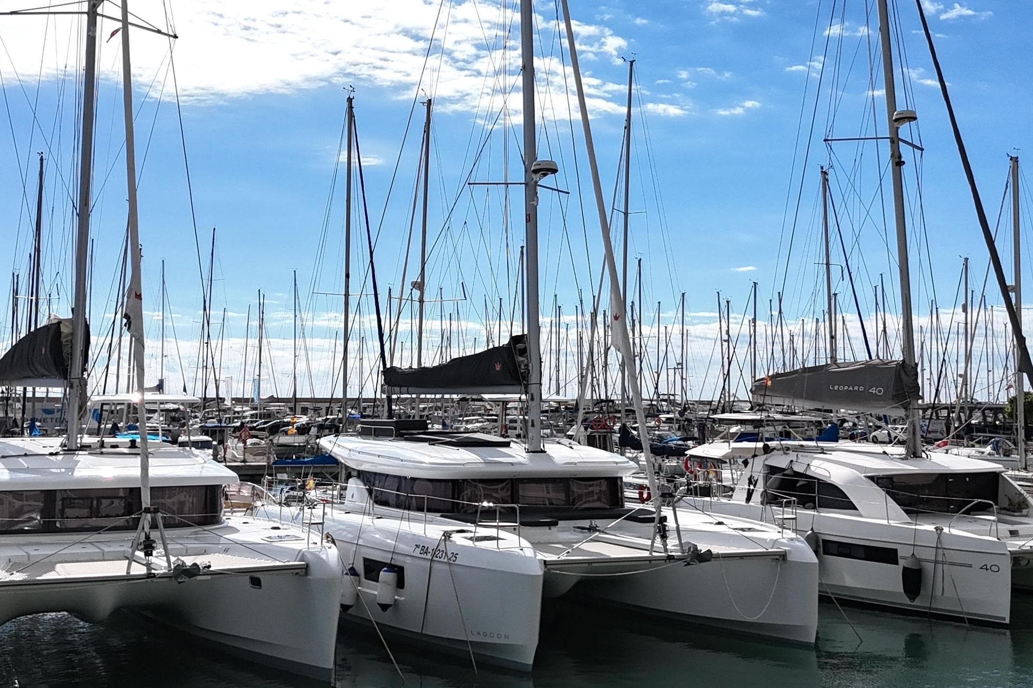 Marina with Lagoon 43 catamarans, 2025 model, under a clear blue sky.