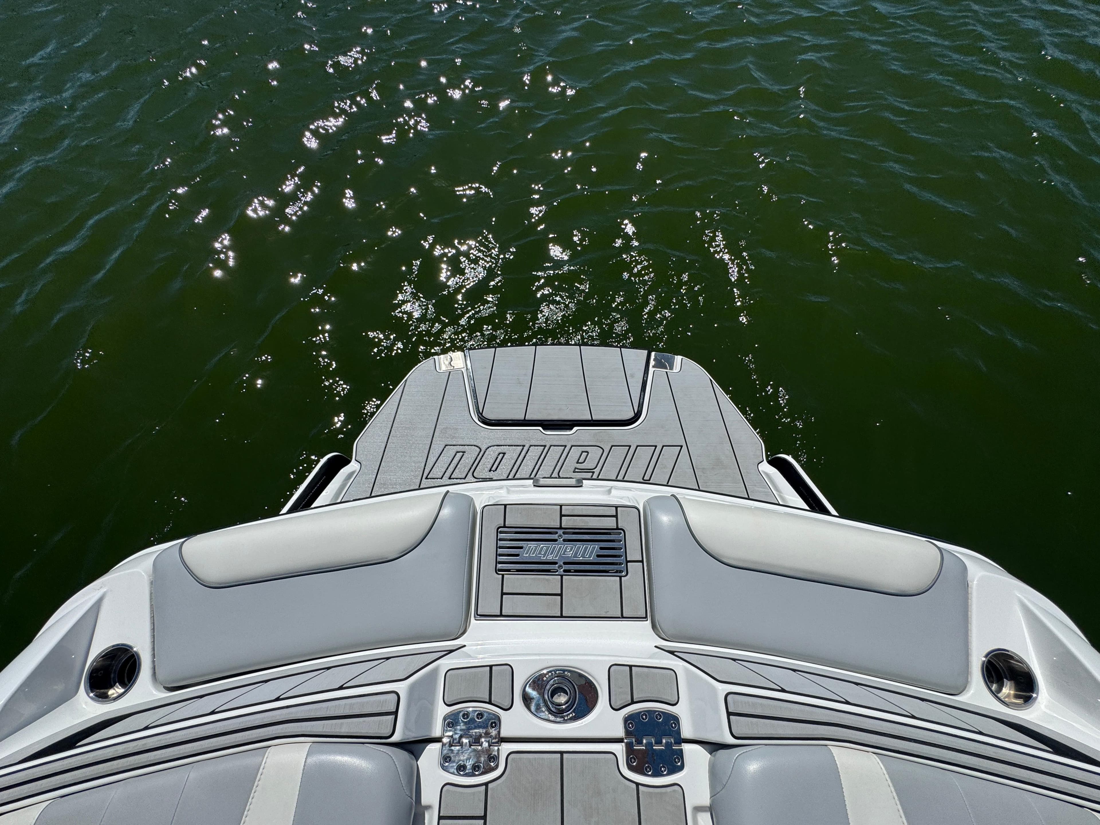2022 Malibu Wakesetter 24 MXZ boat deck on sparkling water.