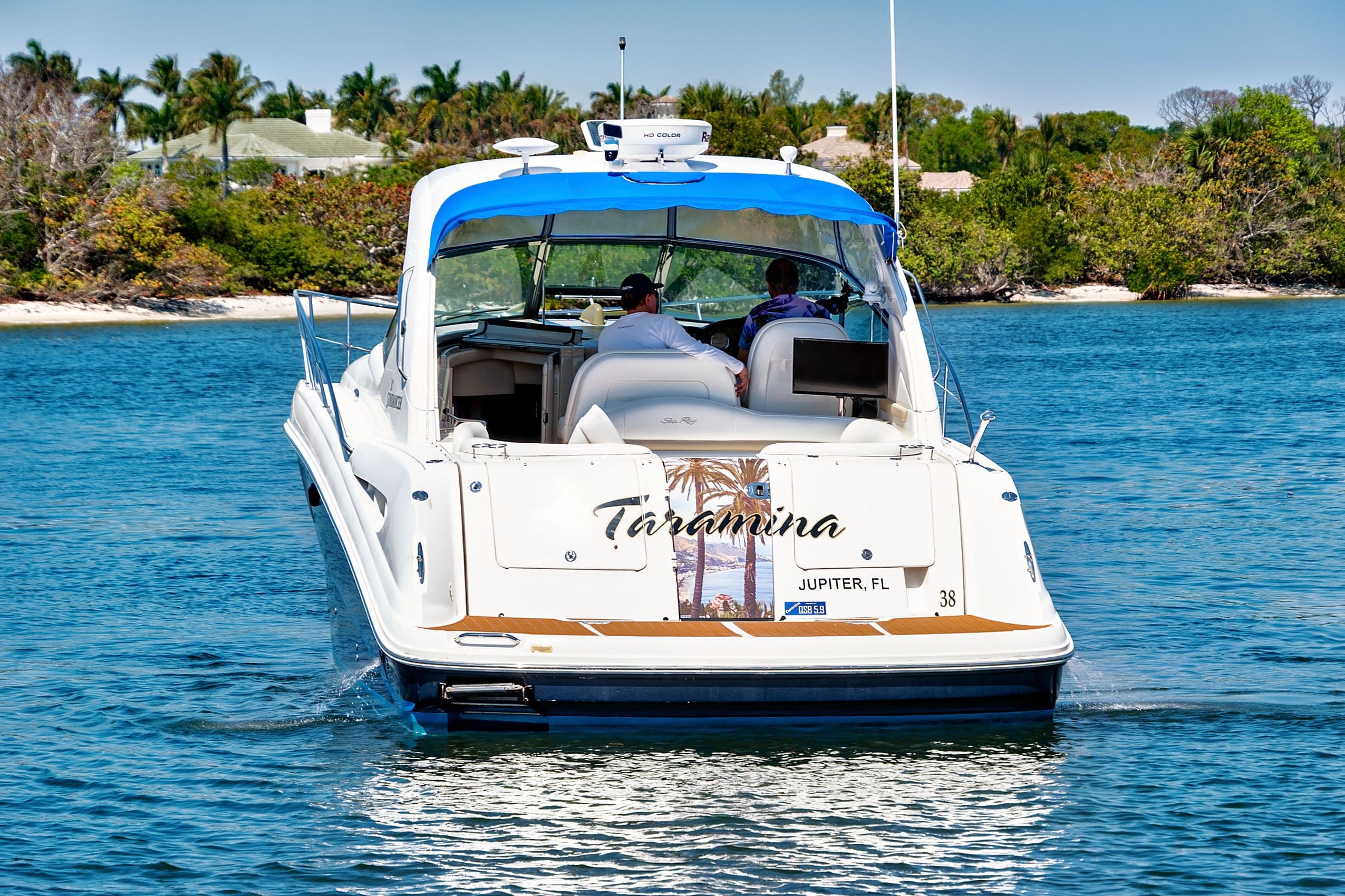 2008 Sea Ray 38 Sundancer on calm waters, tropical backdrop.