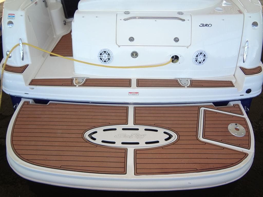 2005 Sea Ray 320 Sundancer swim platform with teak decking and storage hatch.