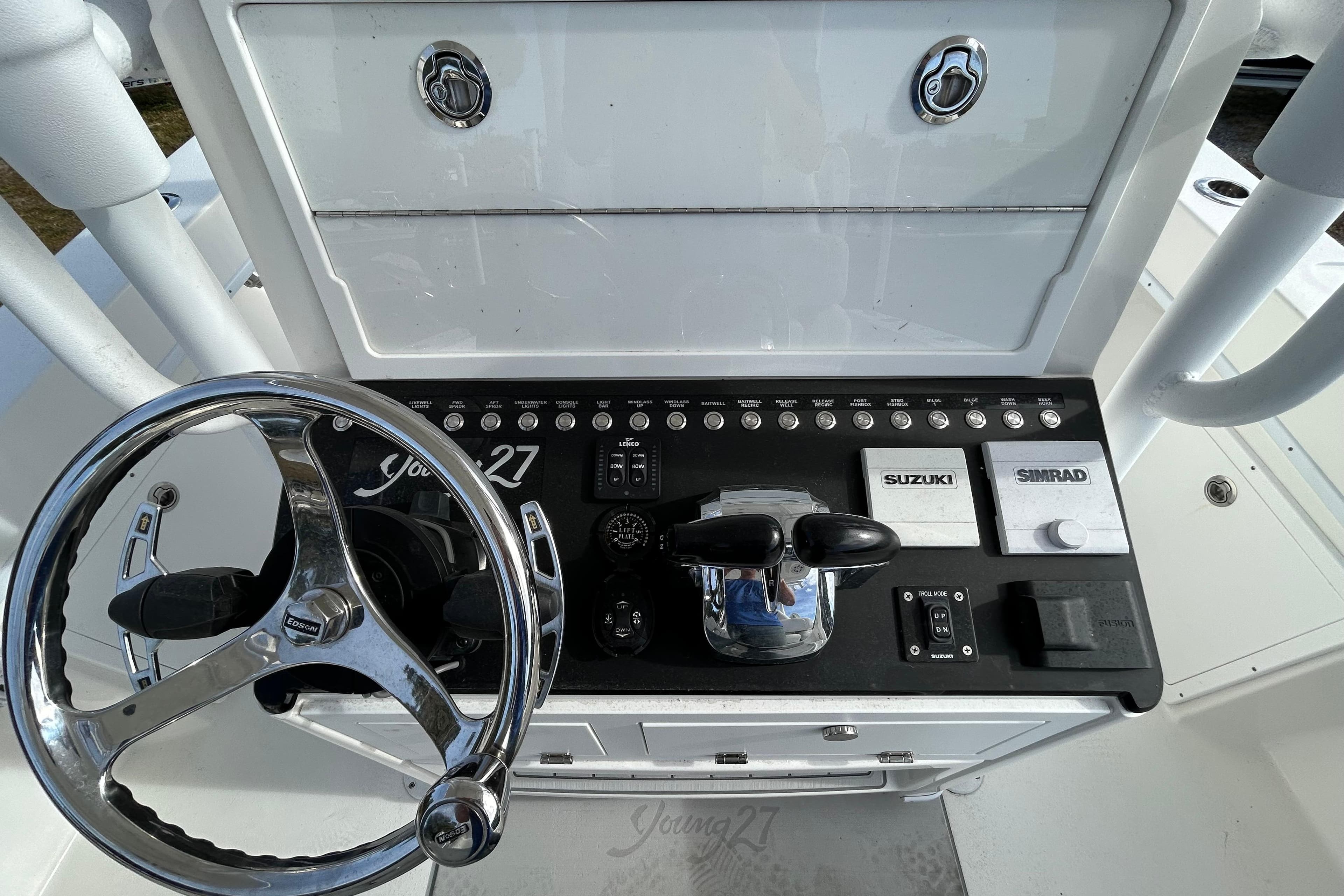 Steering console of 2022 Young Boats 27 with Suzuki and Simrad controls.