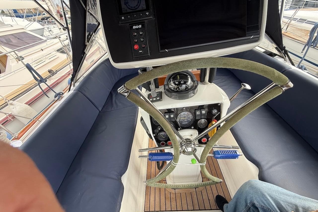 Cockpit of 2002 Moody 47 sailboat with steering wheel and navigation instruments.