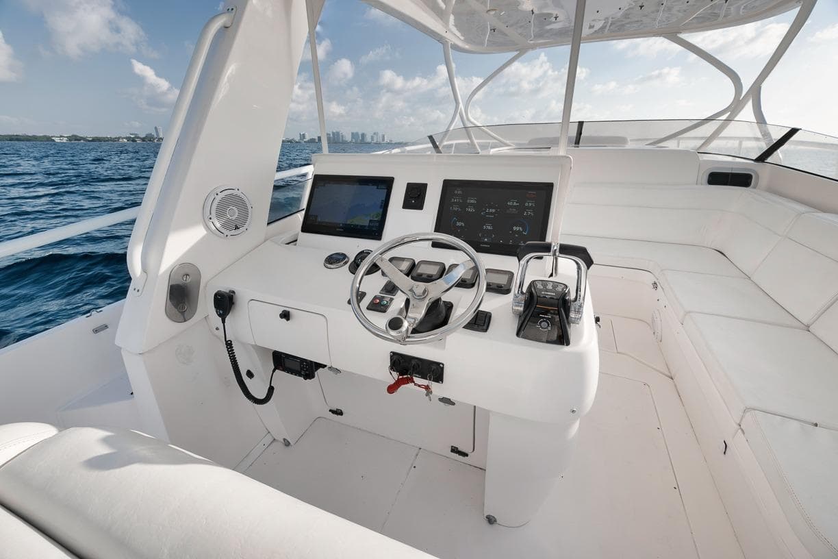 Cockpit of 2018 Intrepid 390 Sport Yacht with steering wheel and navigation controls.