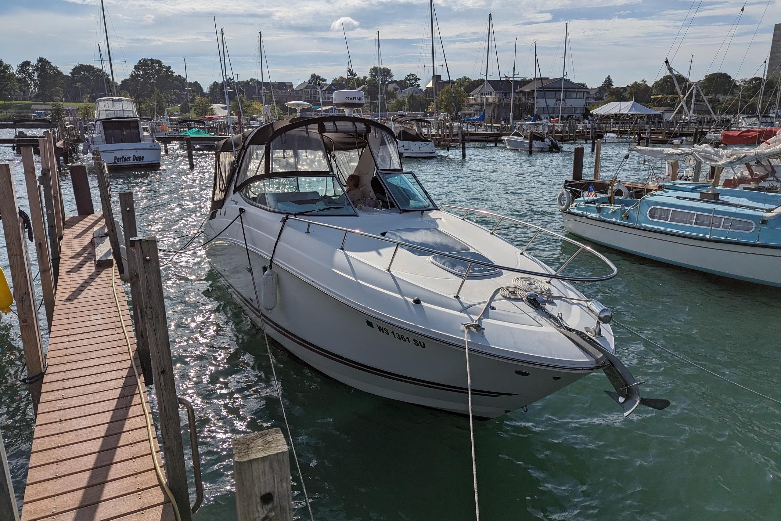 2010 Sea Ray Sundancer 280 docked at a marina, surrounded by other boats.