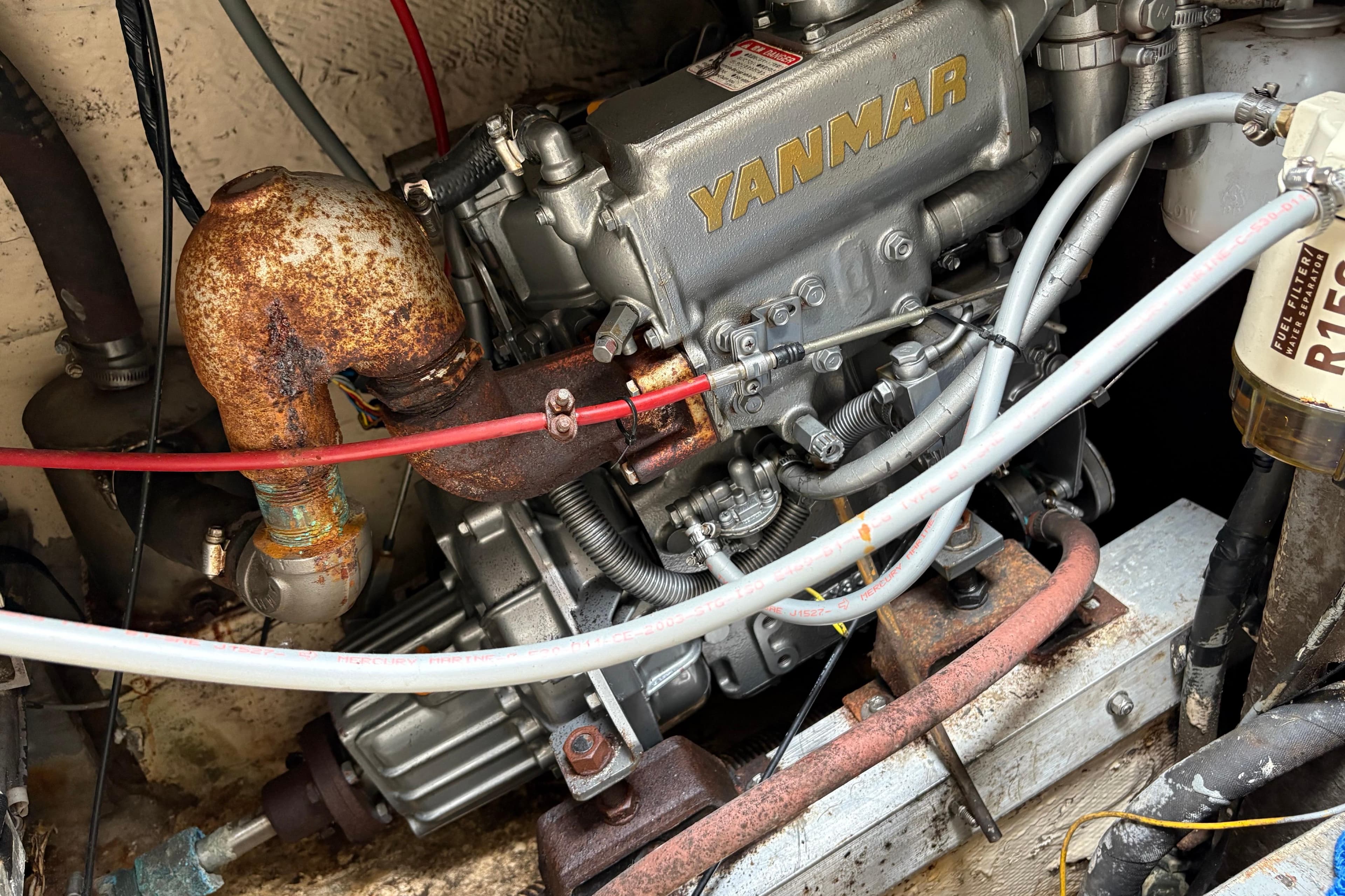 1978 C&C 34 sailboat engine compartment with Yanmar diesel engine and fuel filter.