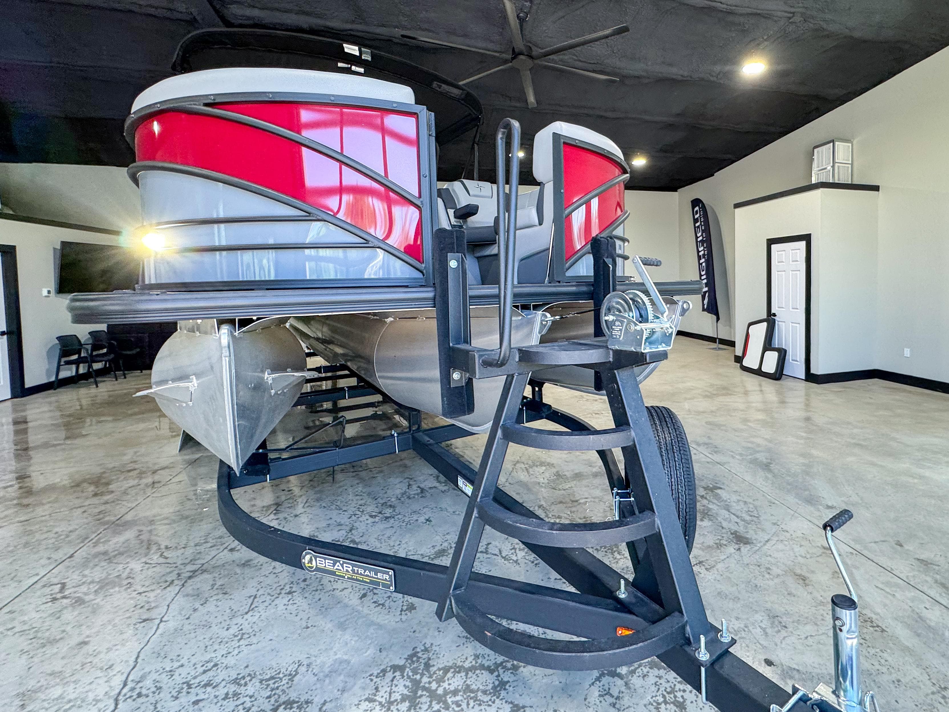 2025 Berkshire 23SBE STS pontoon boat on trailer in showroom.