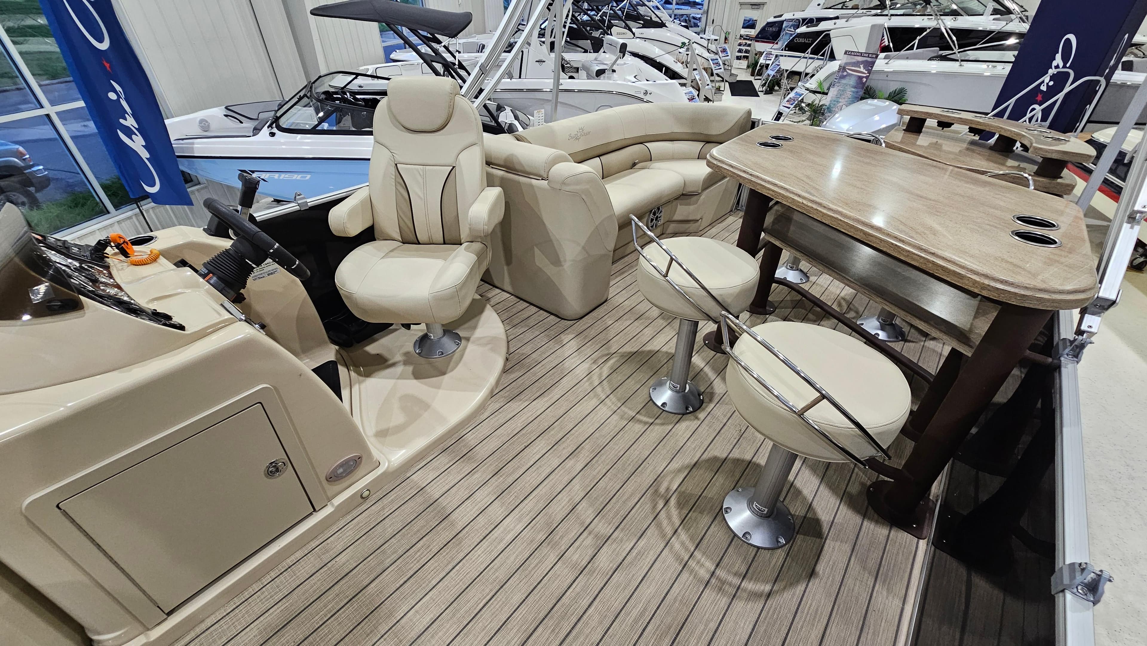 2019 SunChaser Eclipse 8525 Entertainer boat interior with seating and table setup.