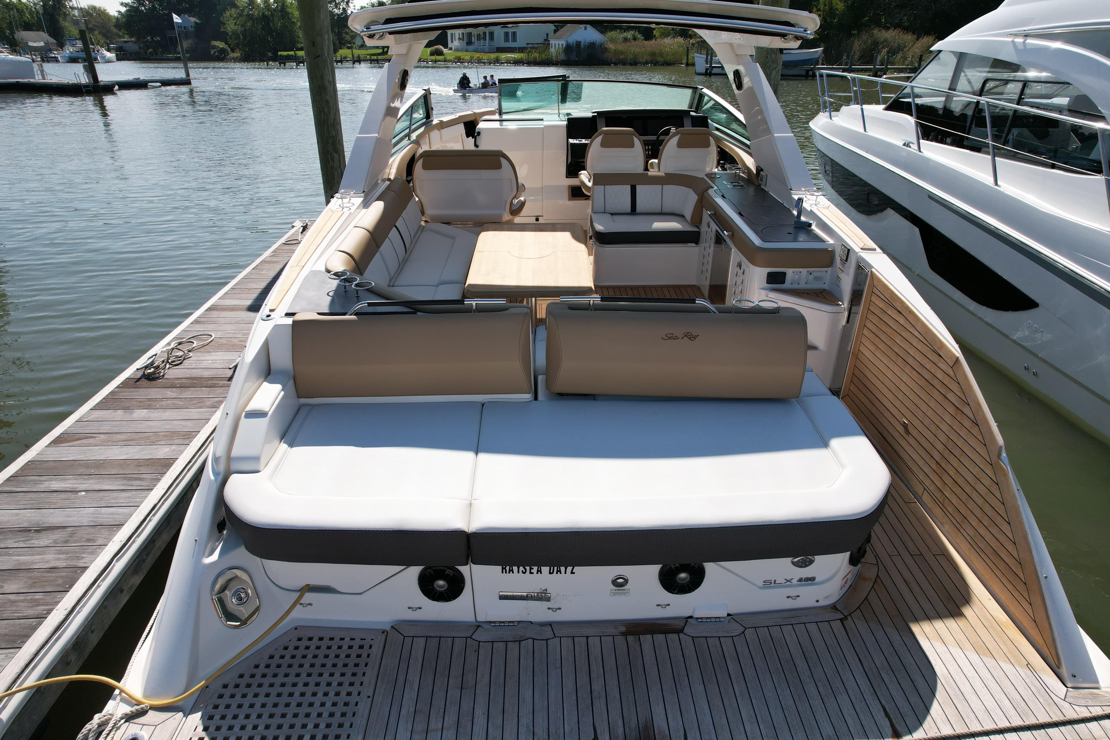 2019 Sea Ray SLX 400 luxury boat docked, featuring spacious seating and sleek design.