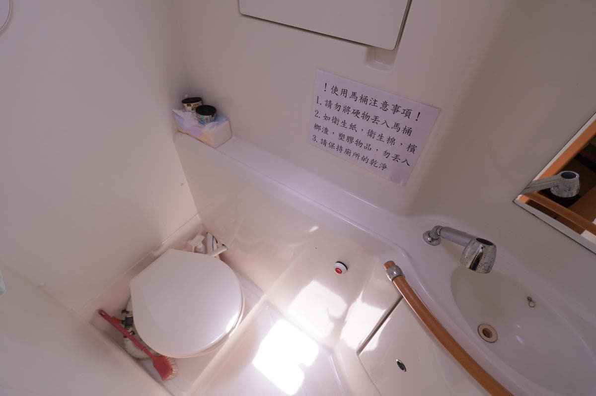 Bathroom interior of a 2013 Lagoon 380 catamaran with toilet and sink.