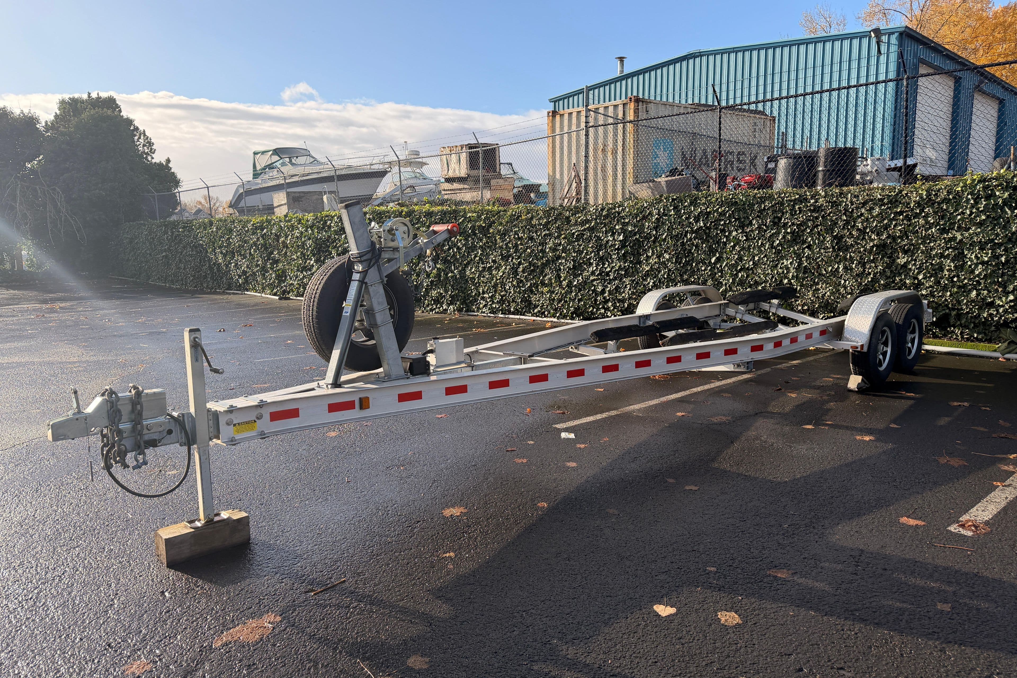 Trailer for 2016 Cutwater C-242 Coupe in parking lot, sunny day.