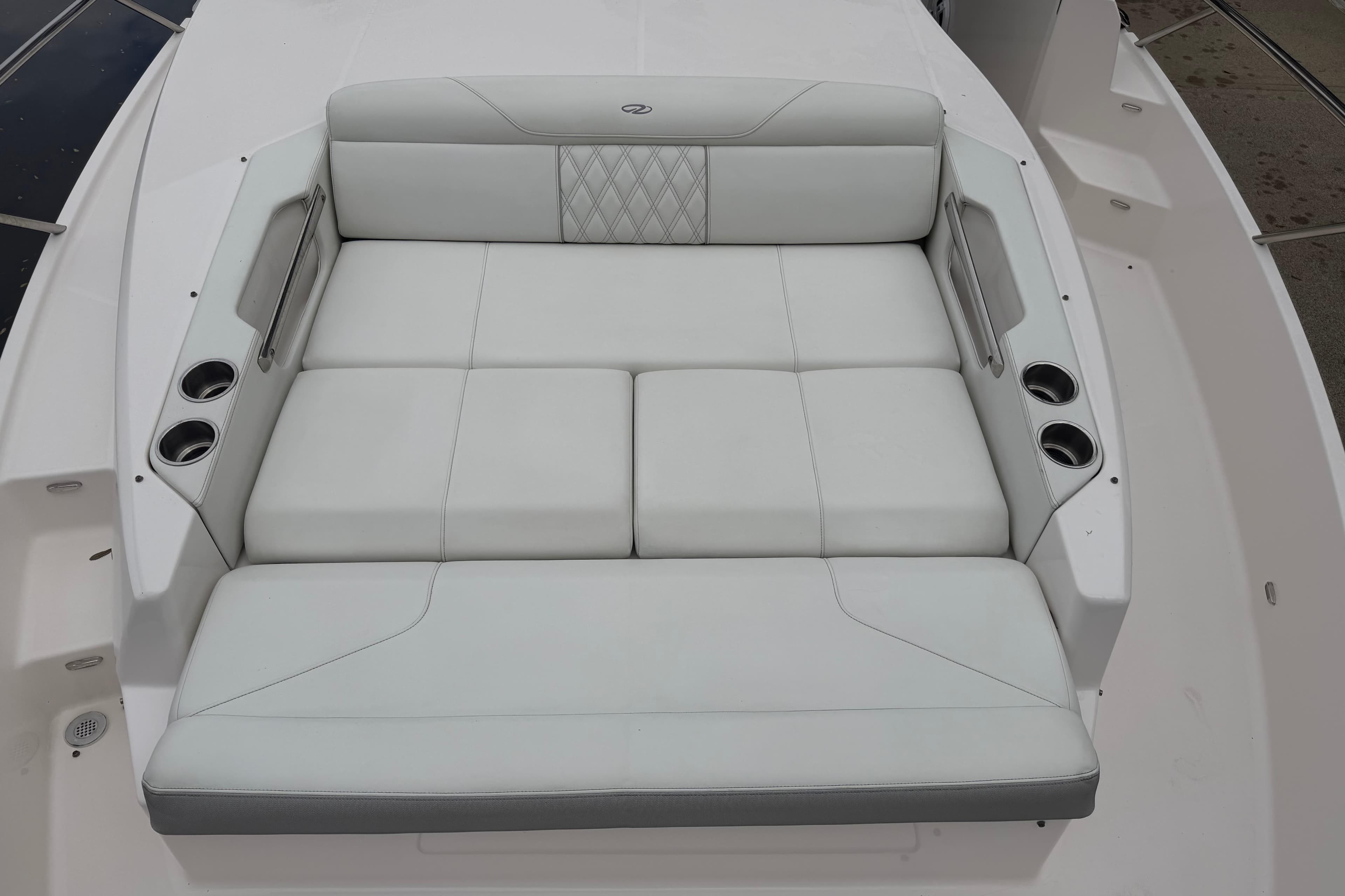 Luxurious seating on 2021 Regal 36 XO boat with cup holders and elegant design.