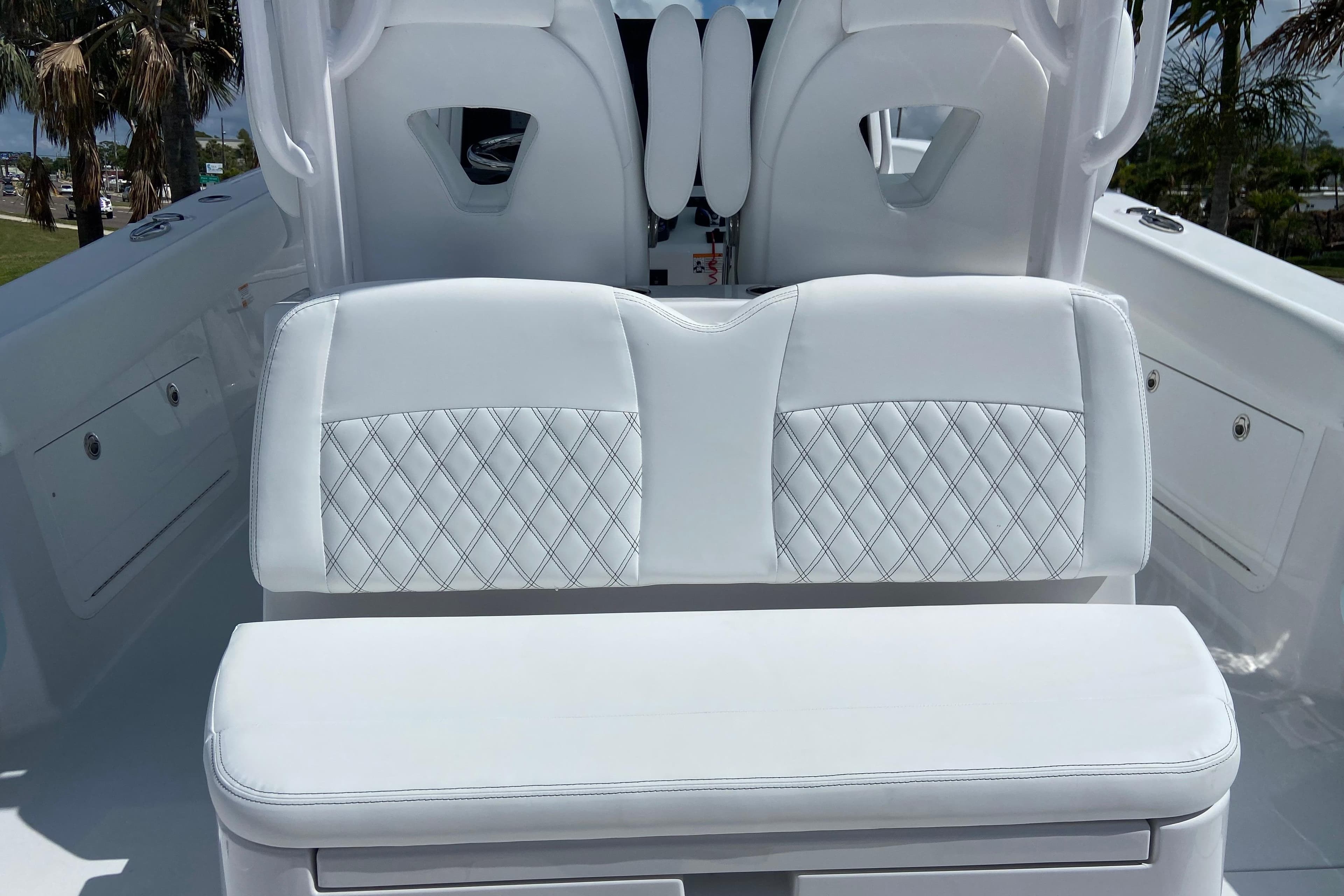 2026 Sportsman Heritage 321 Center Console boat with white cushioned seating and diamond stitching.