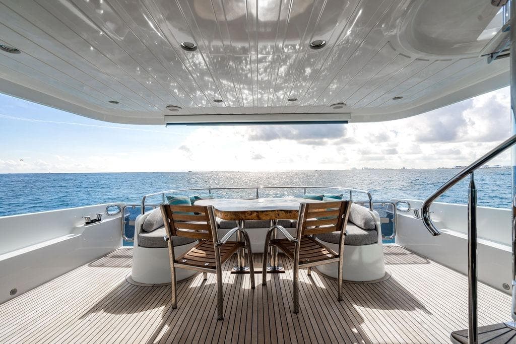 Luxury yacht deck with ocean view, featuring wooden chairs and table, Lanzarote Ventuno 73, 2013.