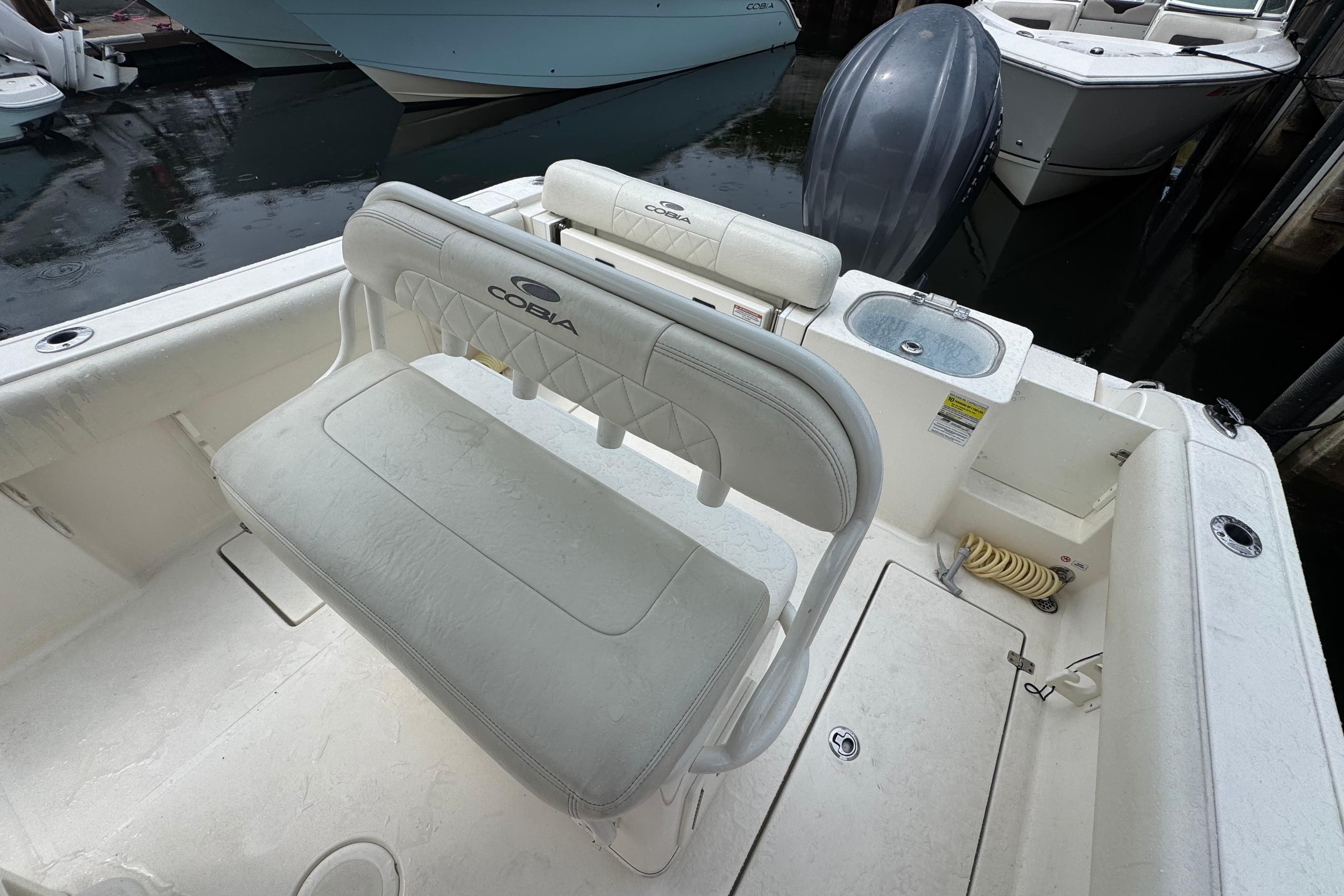 2021 Cobia 237 Center Console boat interior with seating and storage features.