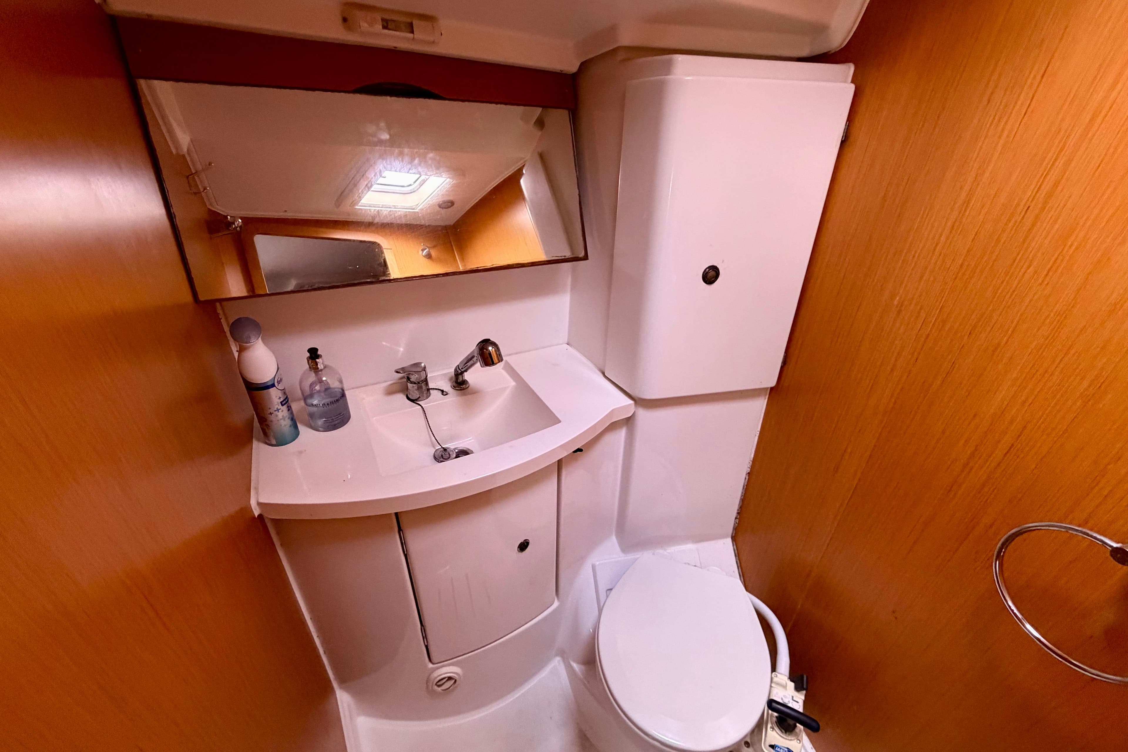 Bathroom interior of 2011 Jeanneau Sun Odyssey 42 DS yacht, featuring sink and toilet.