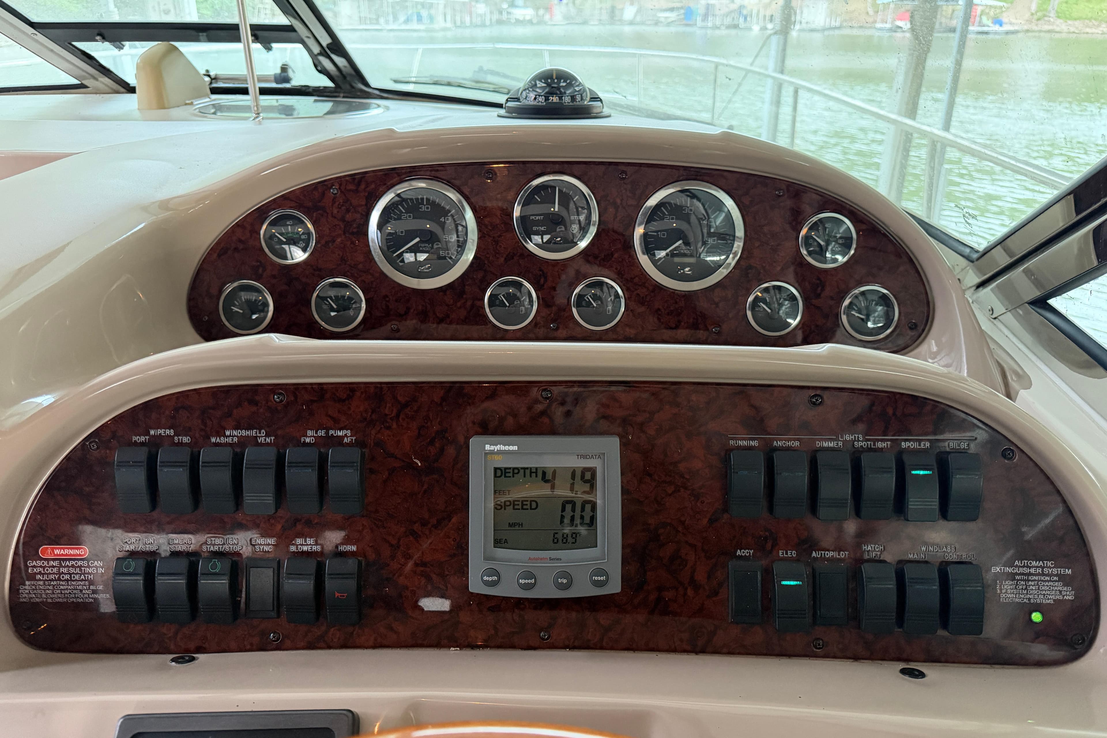 Dashboard of a 2002 Sea Ray 360 Sundancer boat with gauges and controls.