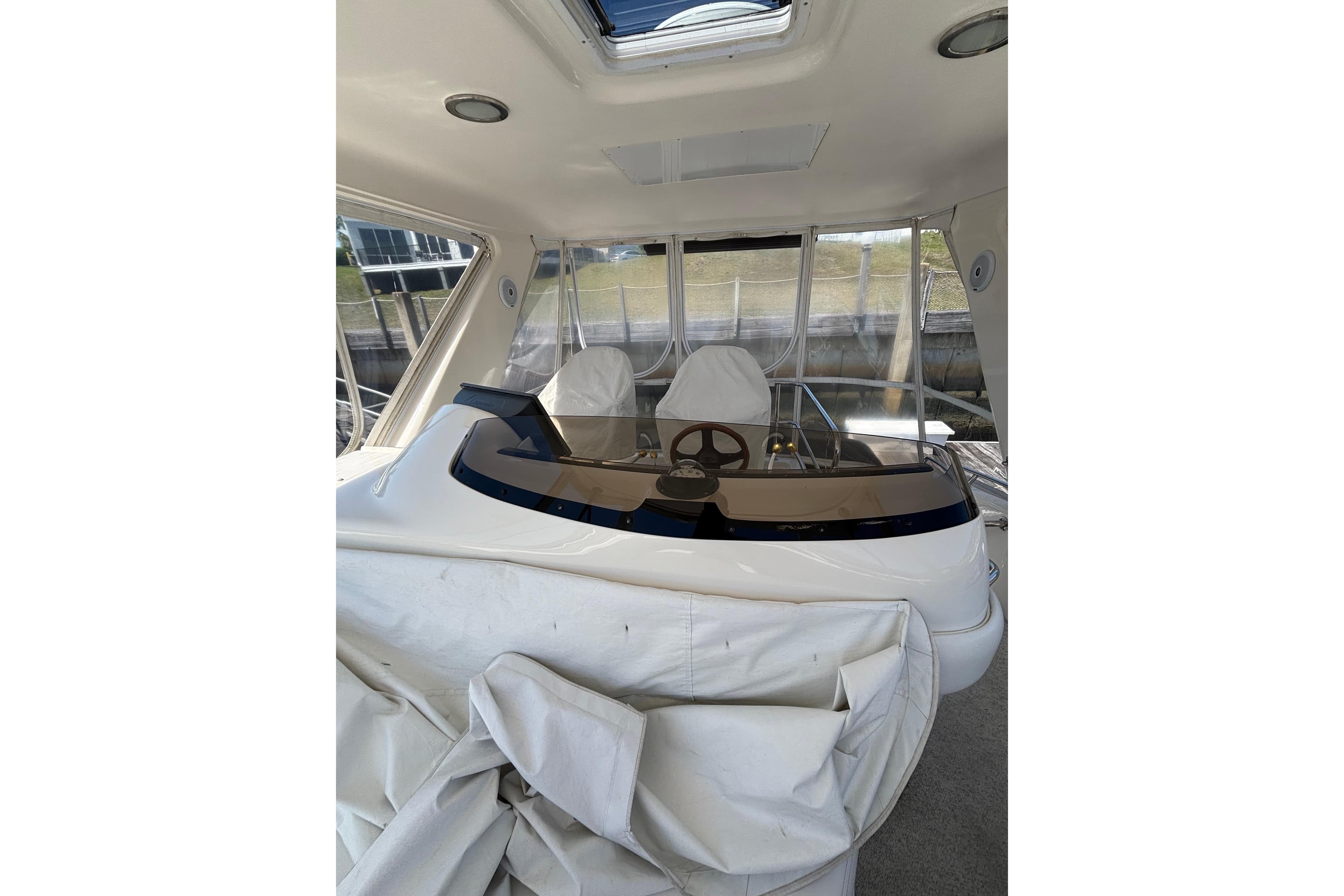 1999 Sea Ray 480 Sedan Bridge helm with covered seating and panoramic windows.