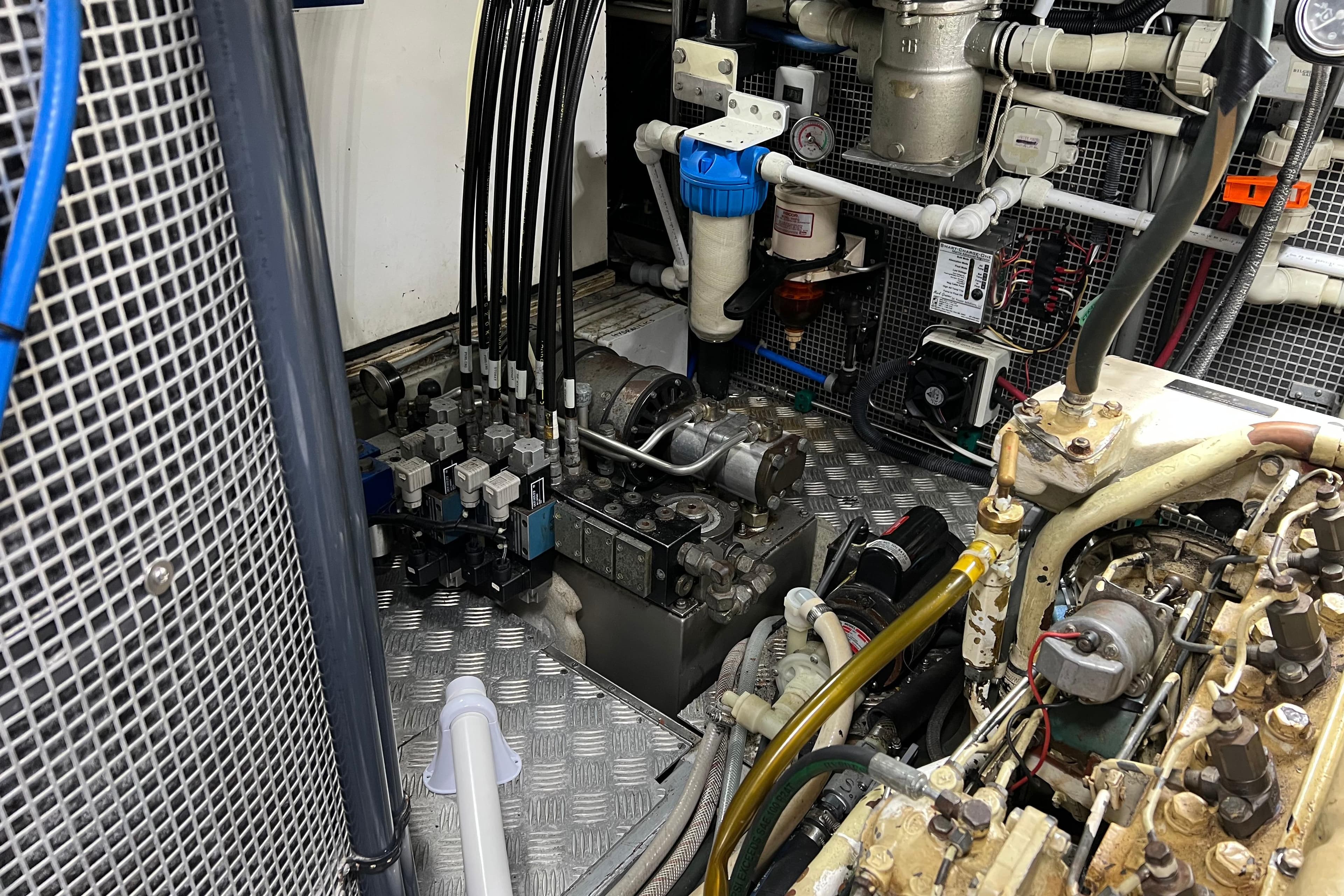 Engine room of a 1990 Trintella 49A yacht, showcasing mechanical components and wiring.