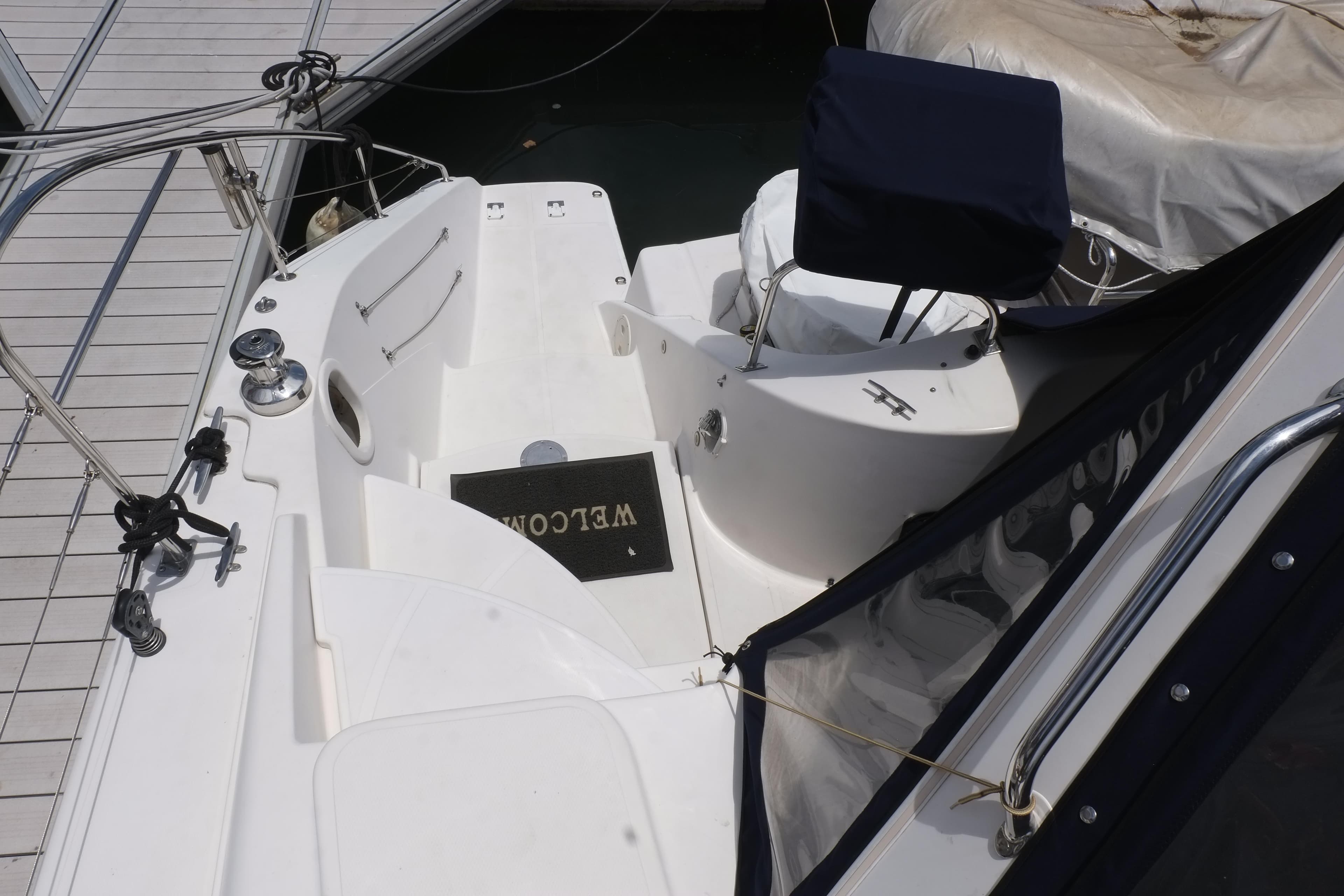 Cockpit of 2007 Lightwave 38 yacht with welcome mat and seating.