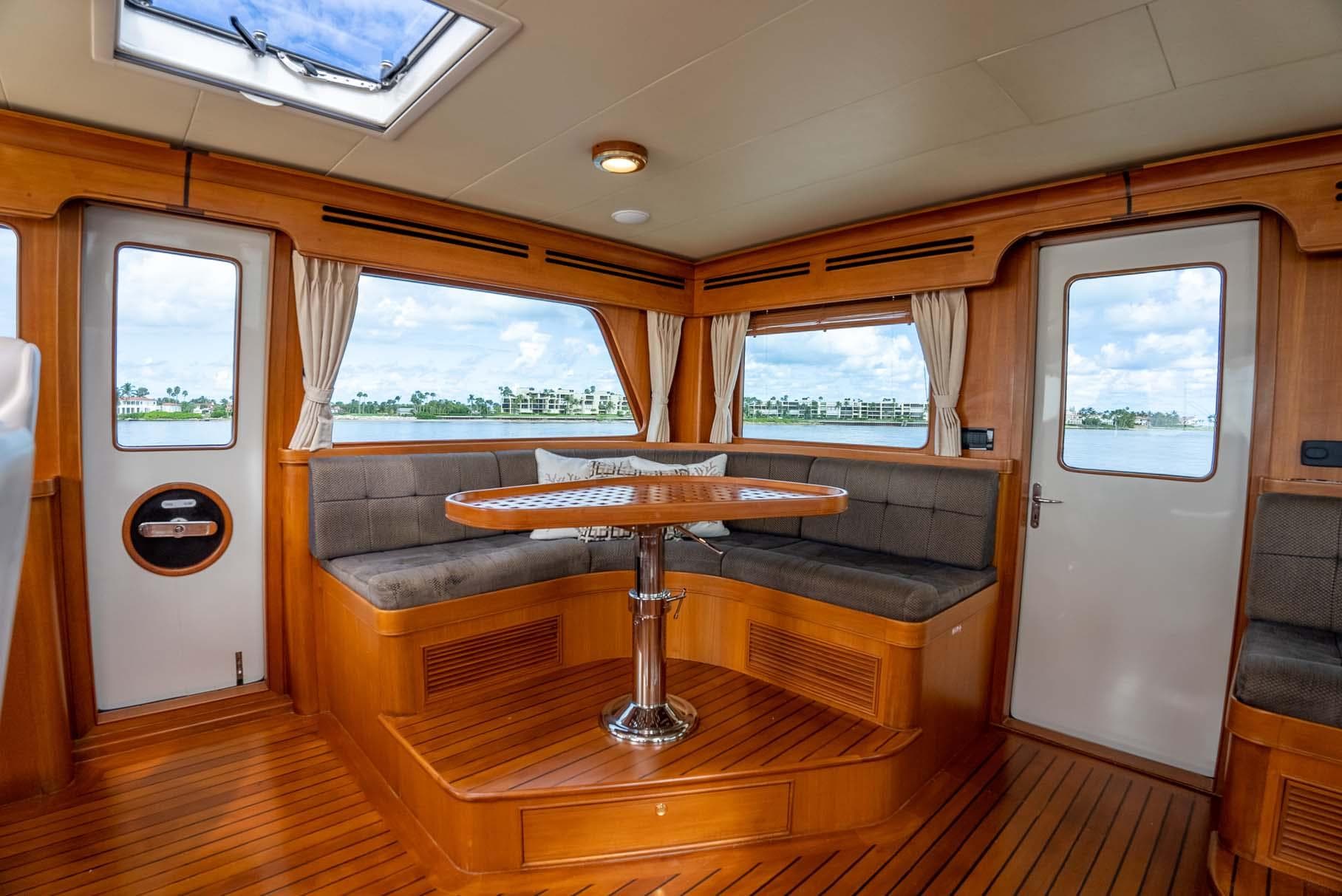 Interior of 2006 Marlow 72E LRC yacht with wood flooring and seating area.
