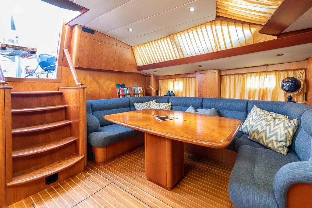 Luxurious Nordia 58 yacht interior, 2001 model, featuring elegant wood finishes and cozy seating area.