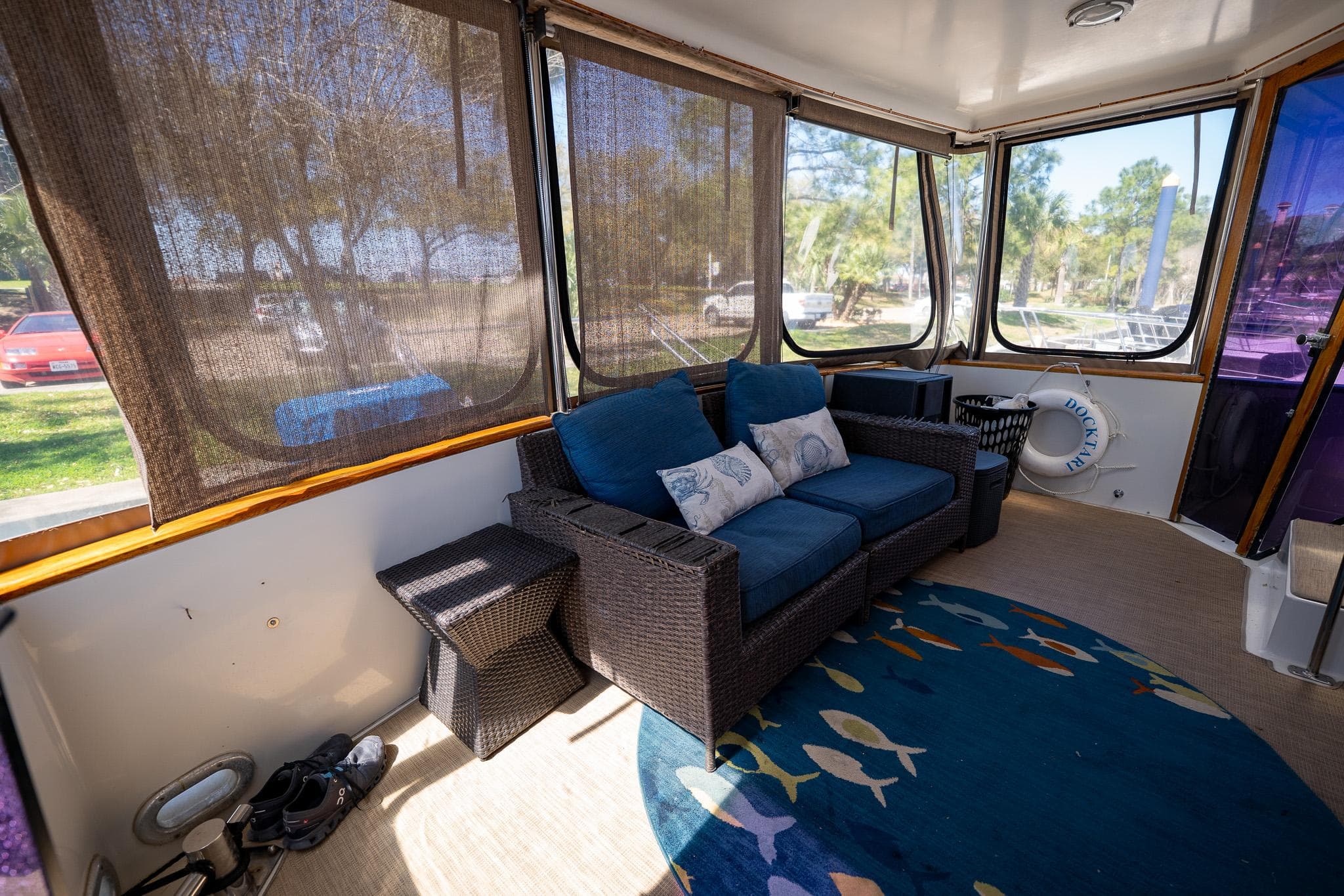 Interior of 1988 Carver 42 Aft Cabin Motoryacht with cozy seating and decorative rug.