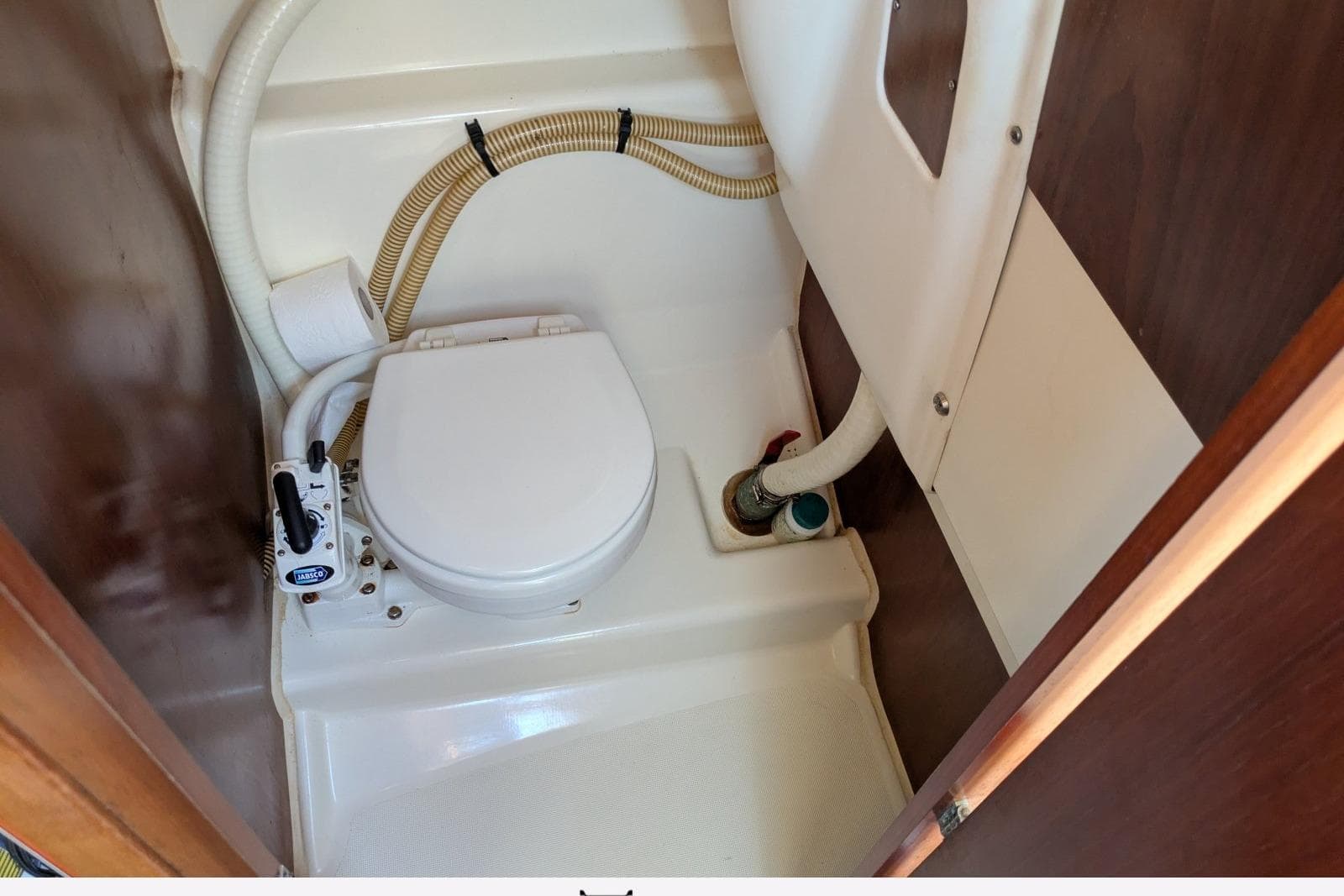 Boat toilet in 2003 Jeanneau Cap Camarat 755 WA cabin, featuring compact marine design.