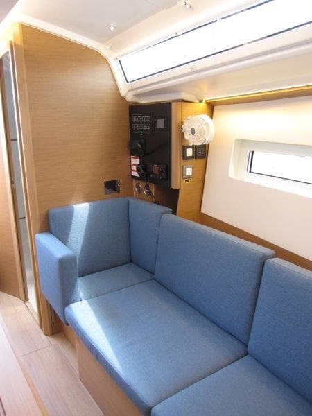 Interior of 2025 Jeanneau Sun Odyssey 350 yacht with blue seating and modern design.