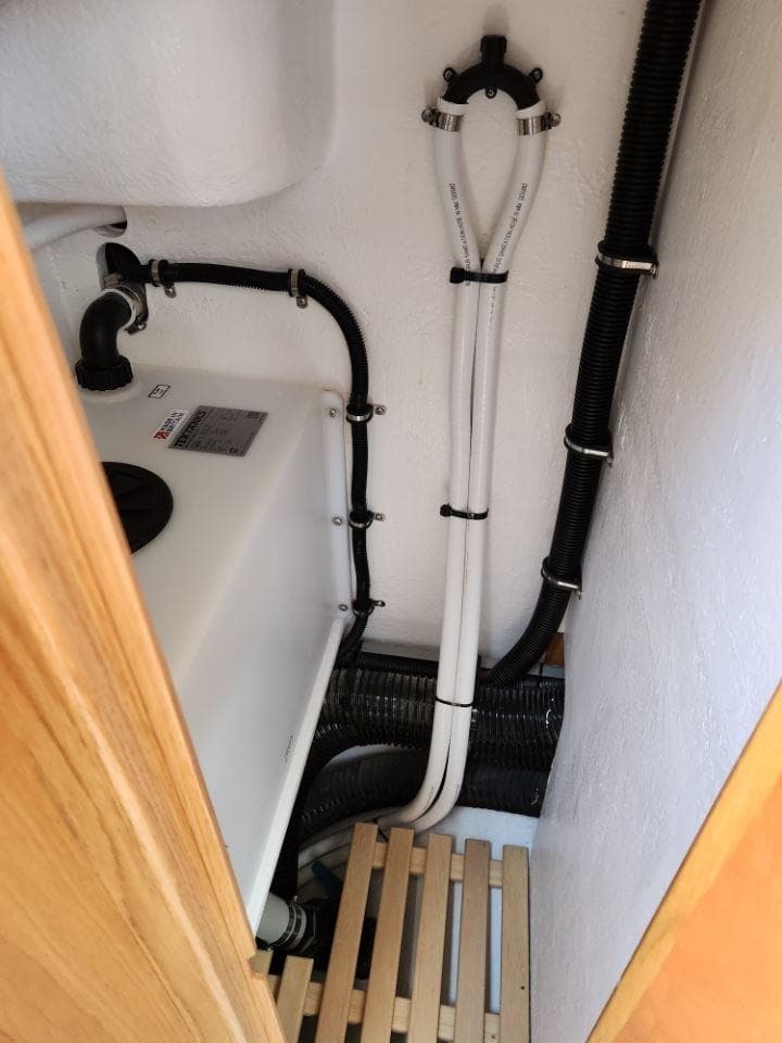 Rustler 37 yacht plumbing system, 2025 model, featuring pipes and wooden flooring.