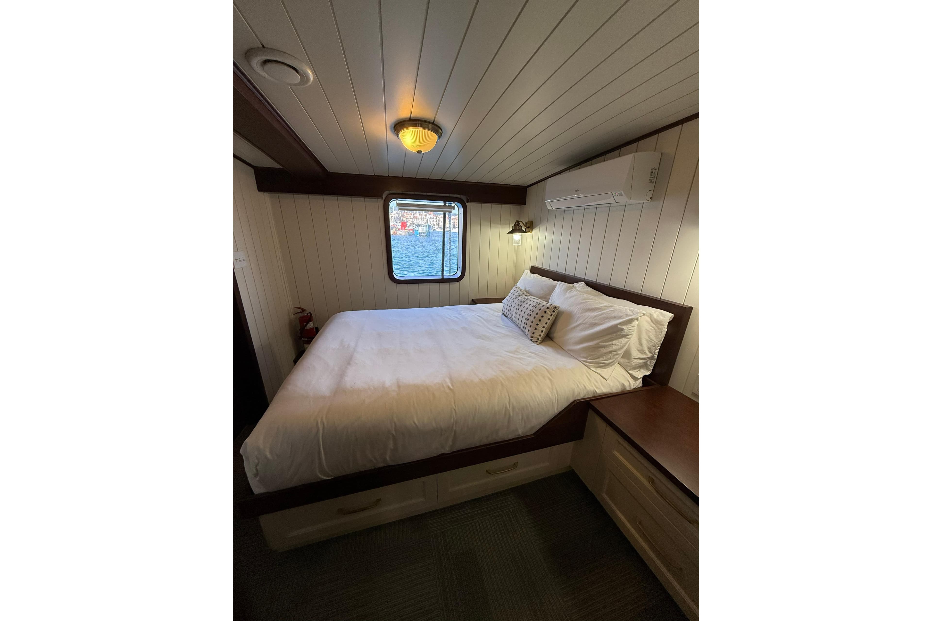 Cozy ship cabin bedroom with window view, Custom Glovertown Shipyard 2021 model.