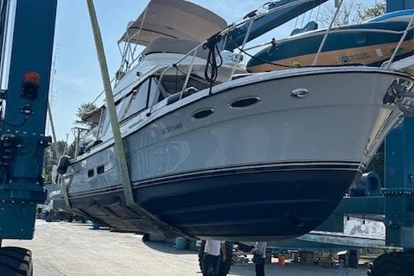 2022 Cutwater C-32 CB boat being lifted at a marina.