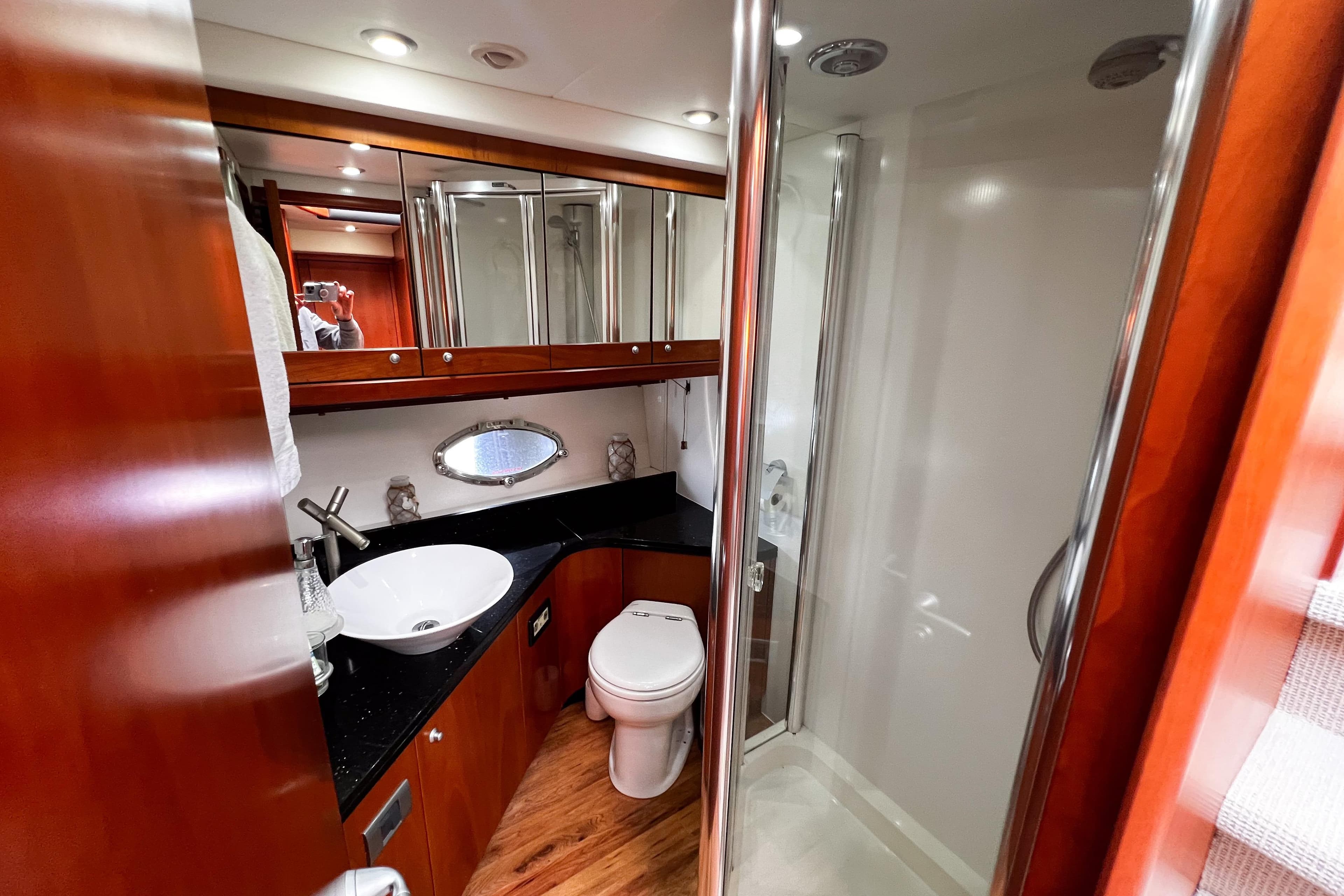 Luxurious bathroom in 2007 Sunseeker Manhattan 66 yacht with modern fixtures and wood accents.