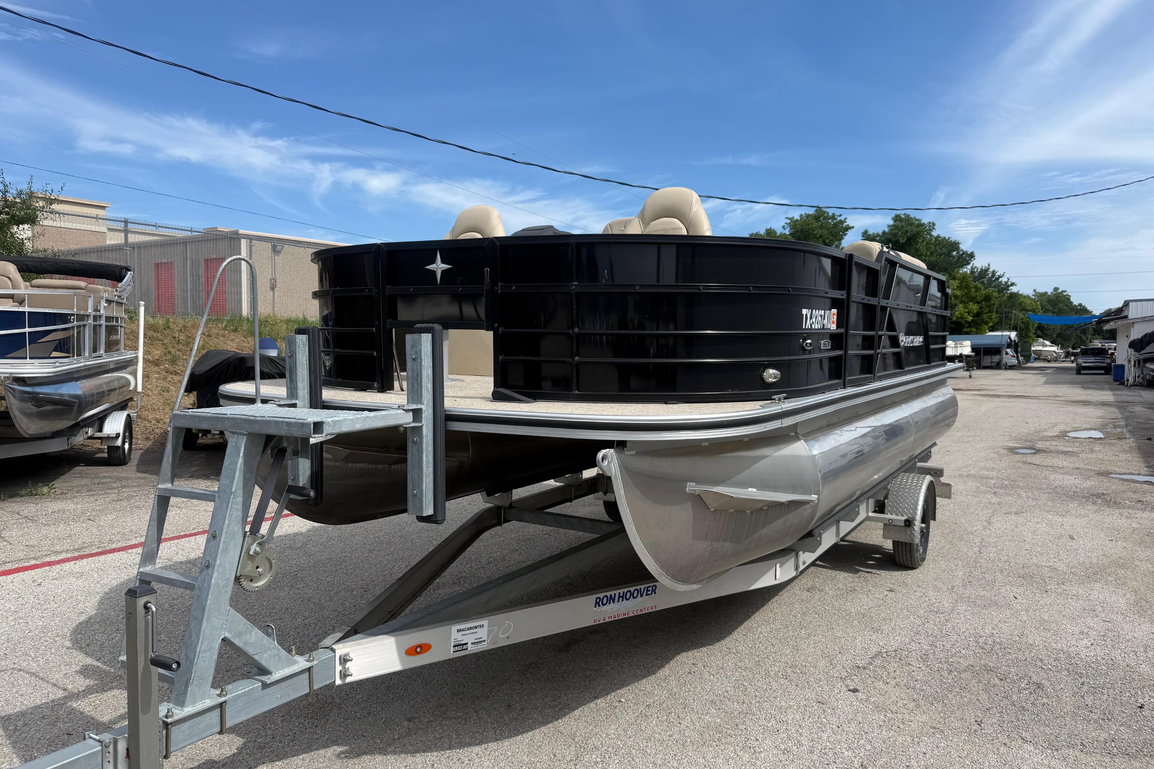 2023 Berkshire 20A CTS pontoon boat on trailer, parked outdoors under blue sky.