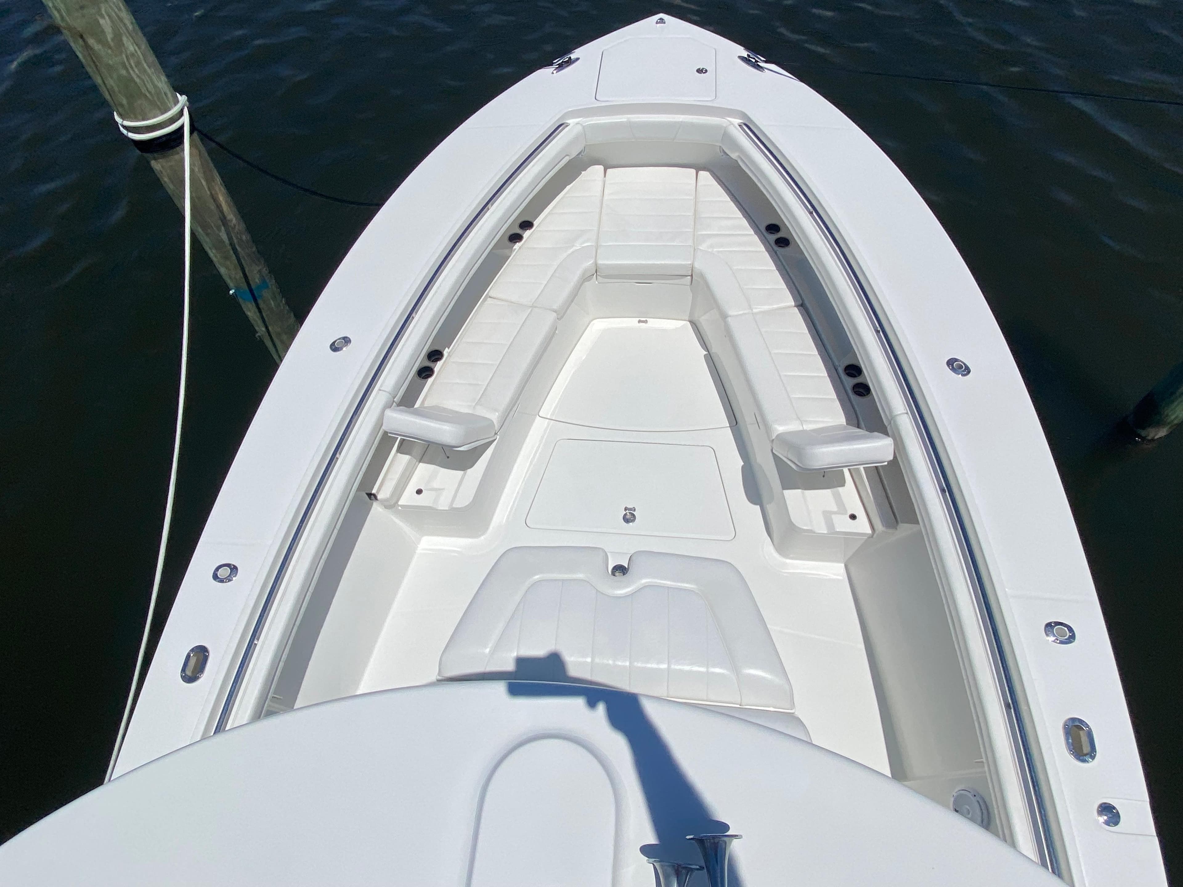 2016 Regulator 41 boat bow with white seating, docked on calm water.