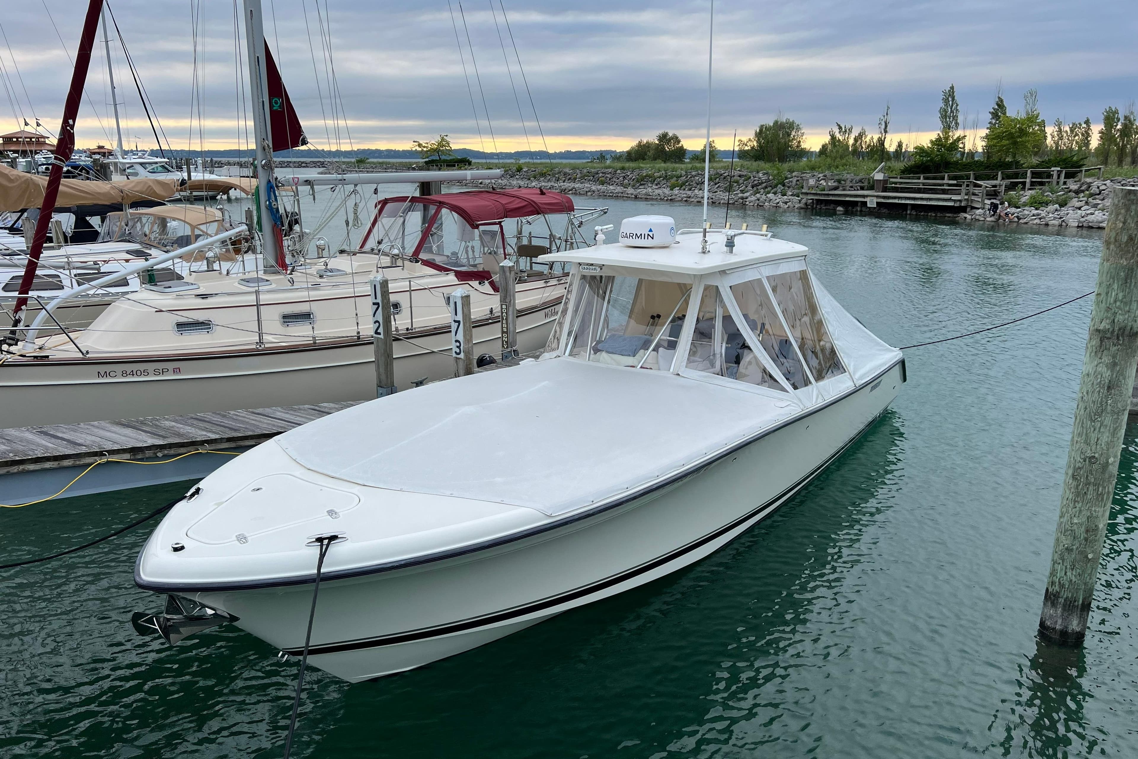 2007 Pursuit C 310 Center Console boat docked in a marina.