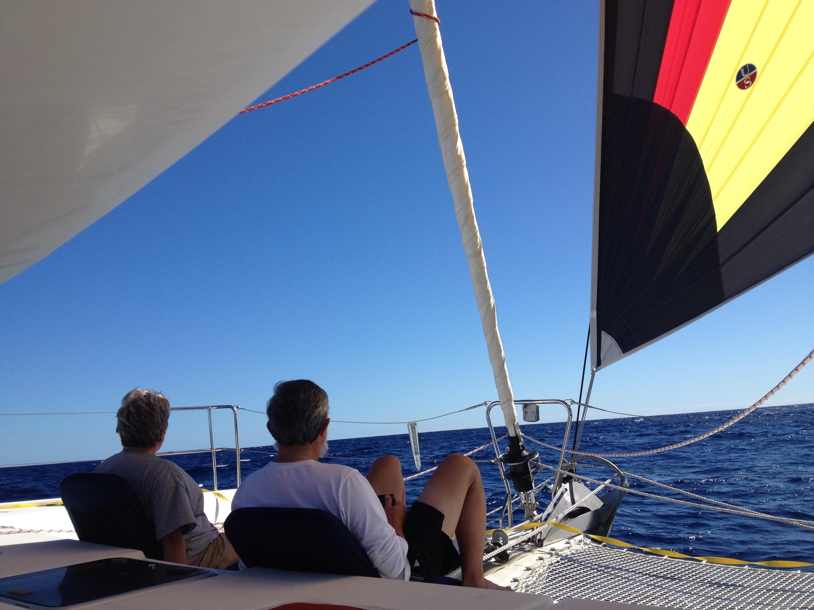 Two people relaxing on a 2007 Lagoon 420 yacht at sea.