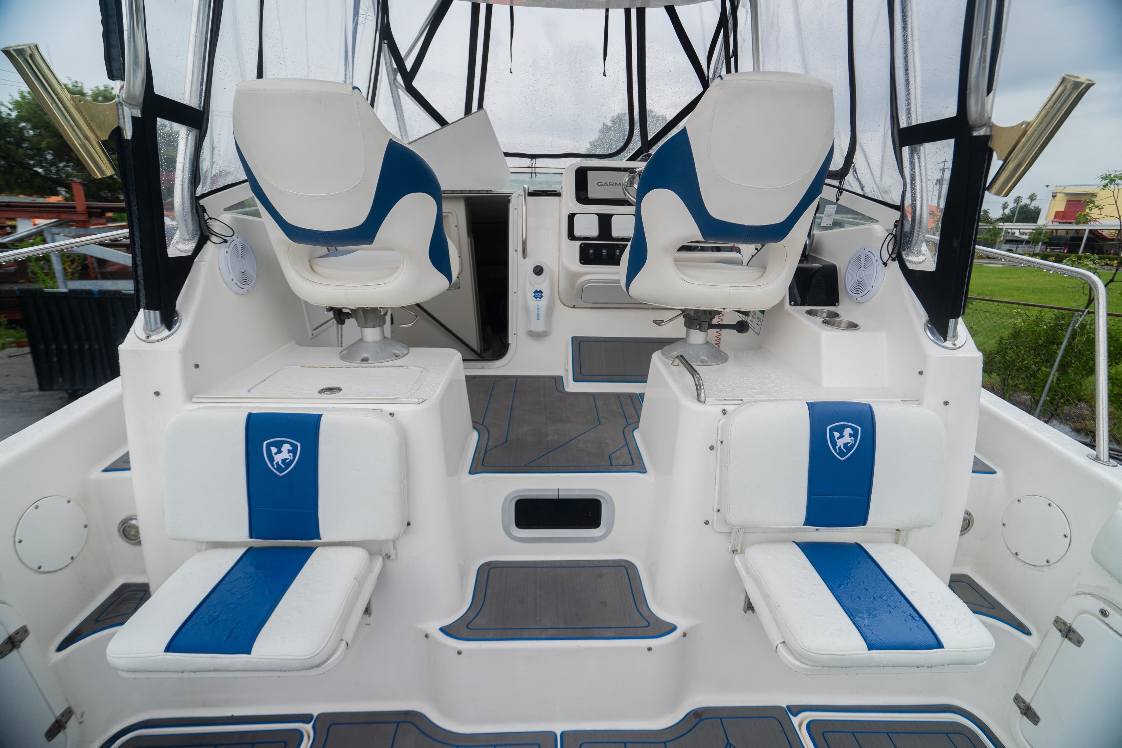 2002 Century 3200 Walk-Around boat interior with blue and white seating.