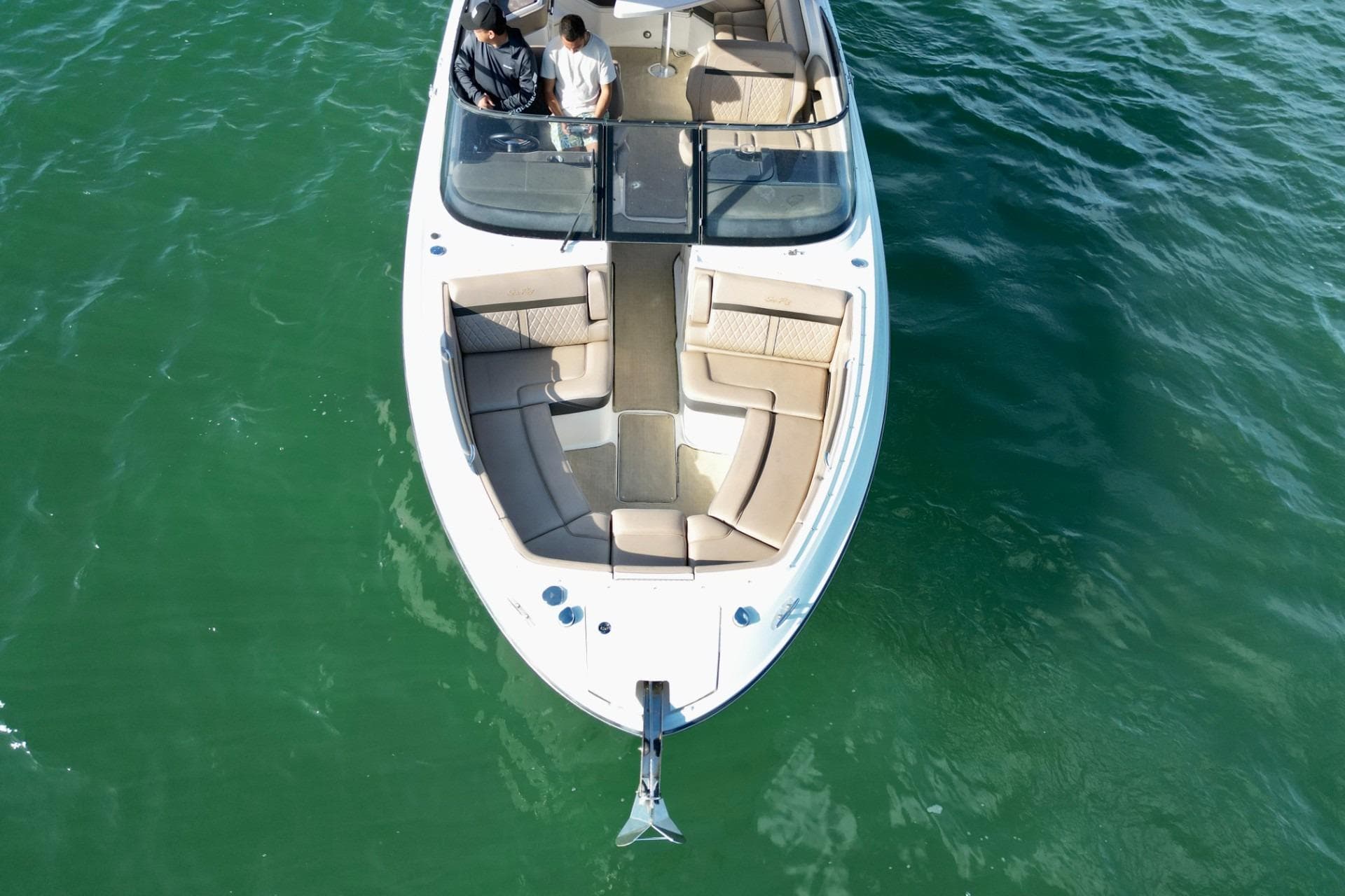 2017 Sea Ray SLX 310 Outboard boat on green water, aerial view.