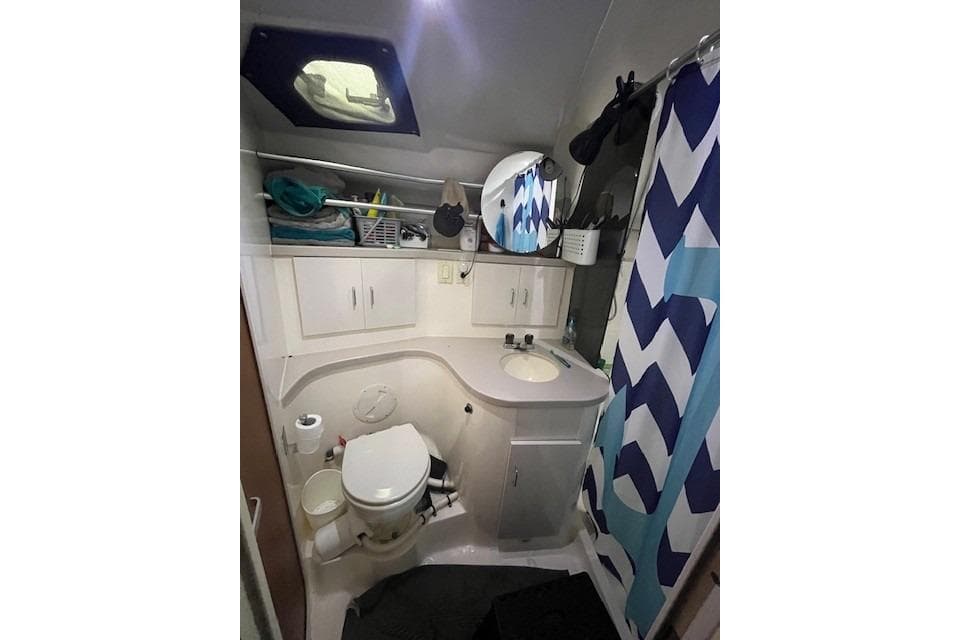 Bathroom interior of 1994 Mainship 40 Sedan Bridge with shower and storage.