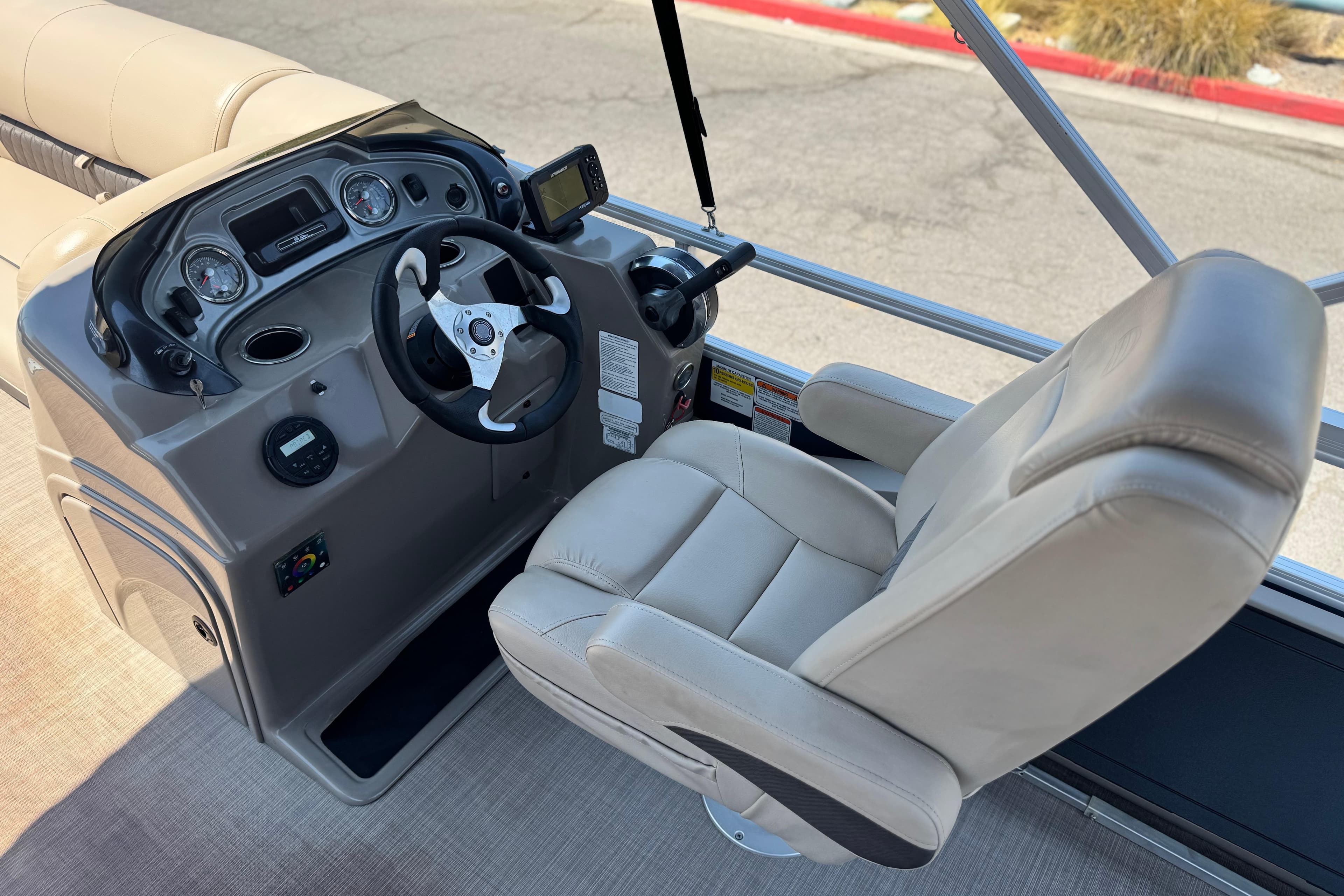 2021 Sun Tracker SportFish 22 DLX helm with steering wheel and captain's chair.