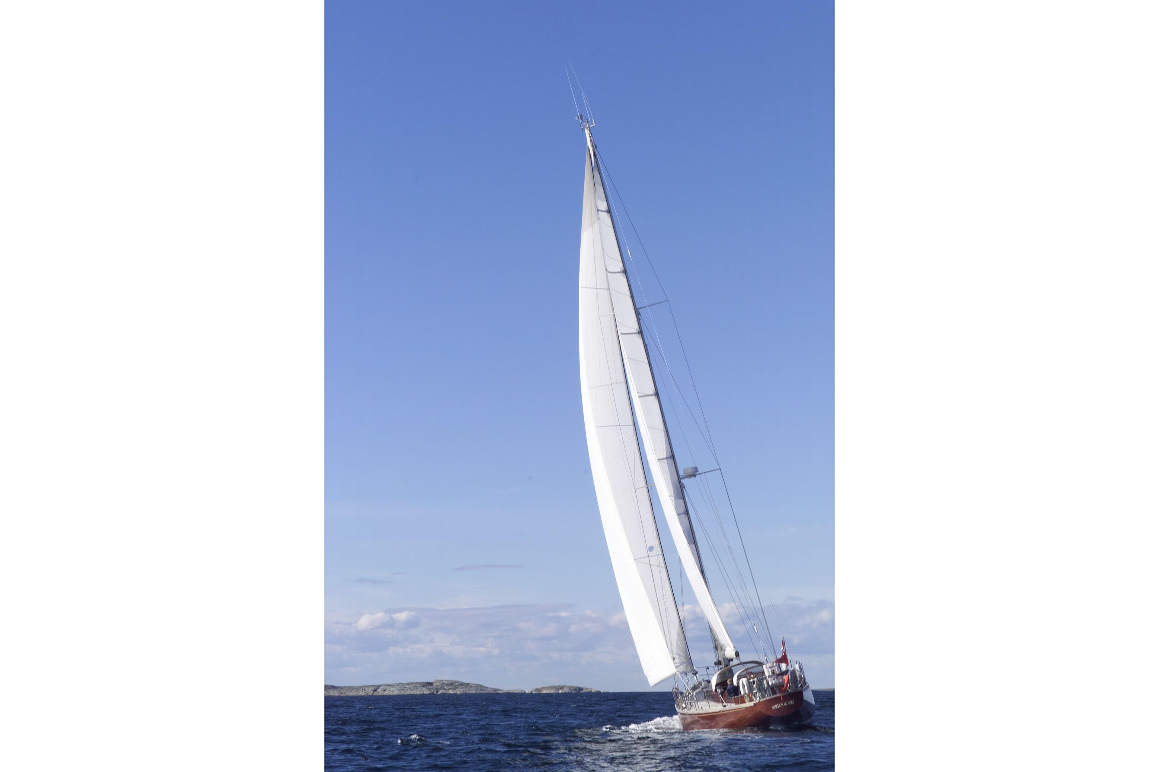 Sailing yacht "Cantiere Valdettaro Le Grazie" from 1977 on open sea under clear blue sky.